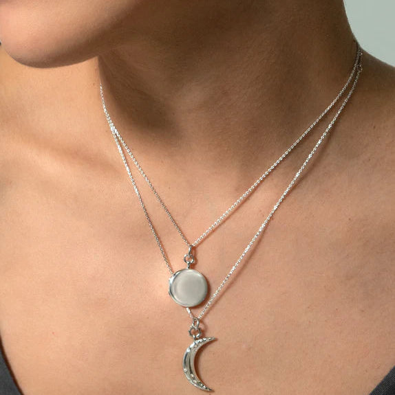 Woman wearing sterling silver locket necklace