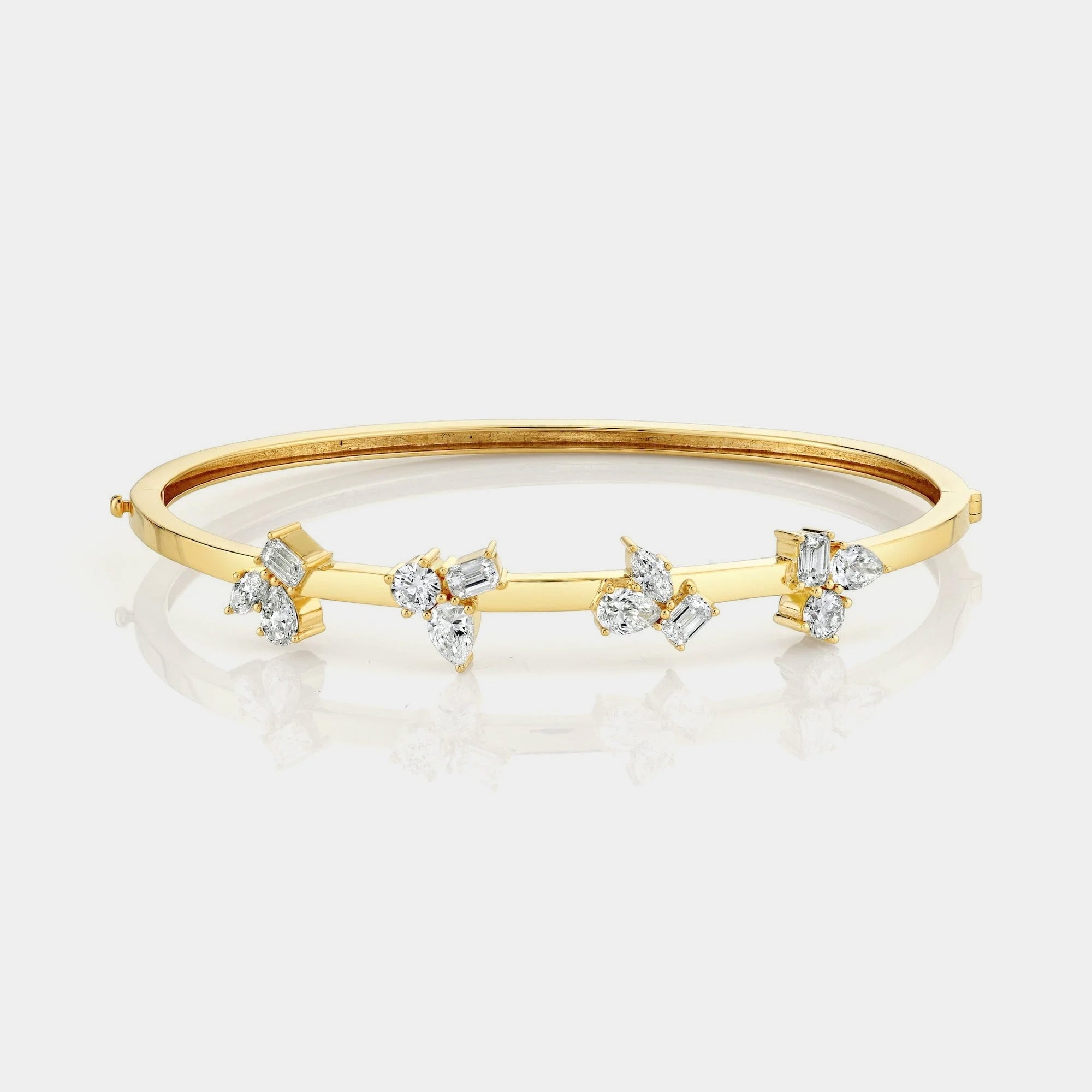 Yellow gold diamond bangle bracelet on grey background, front view