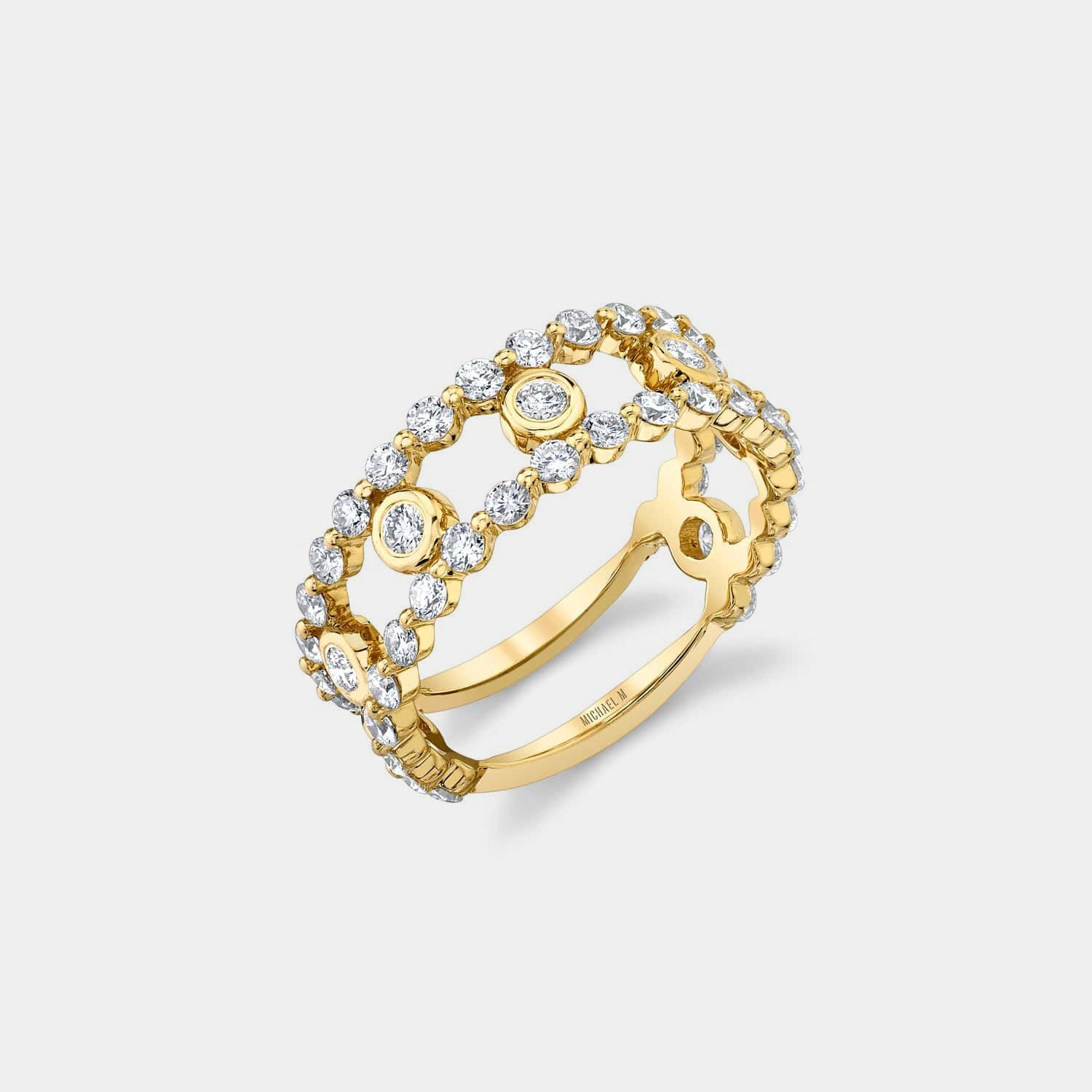 Yellow gold diamond fashion ring on grey background, side angle view