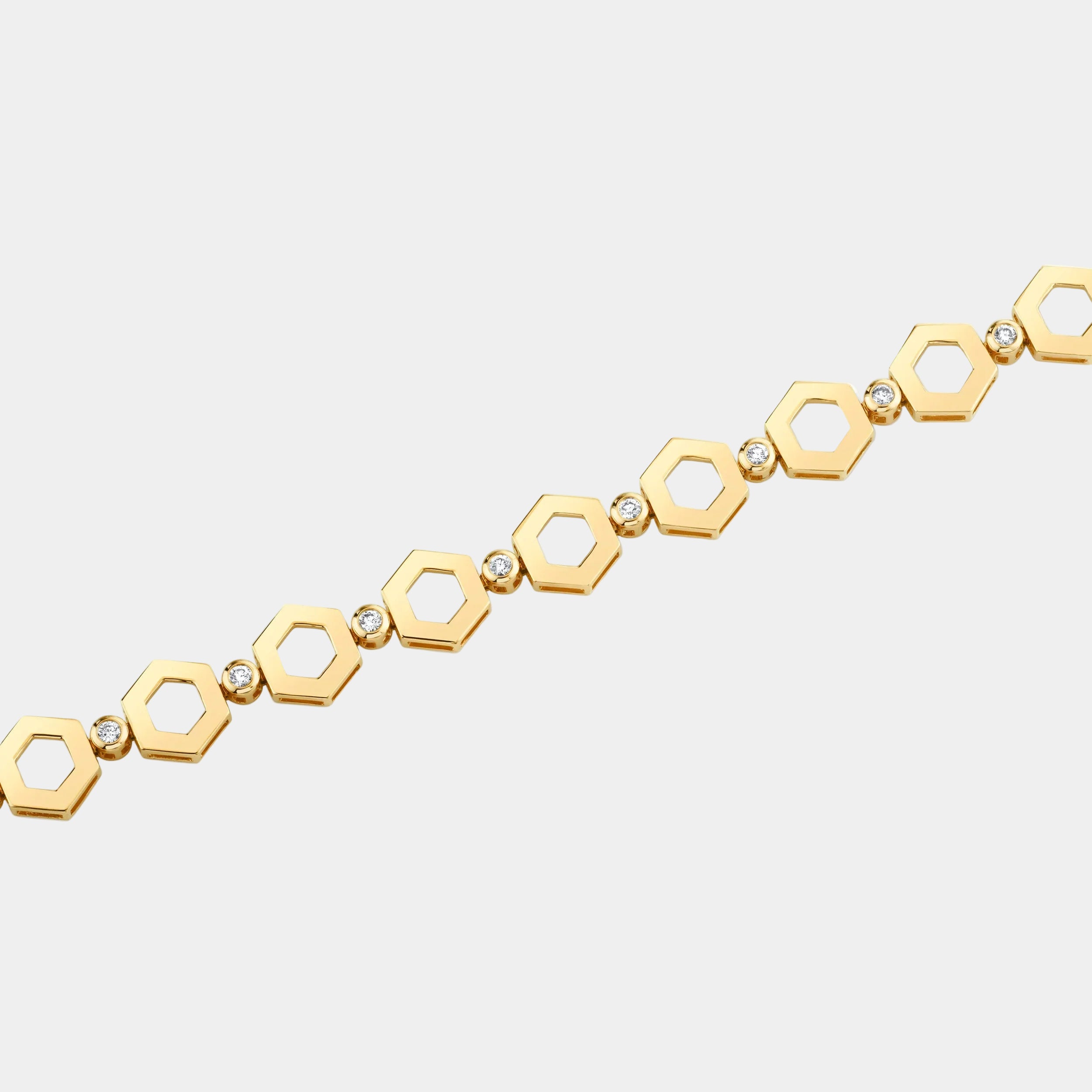 Gold bracelet with hexagonal links on a white background