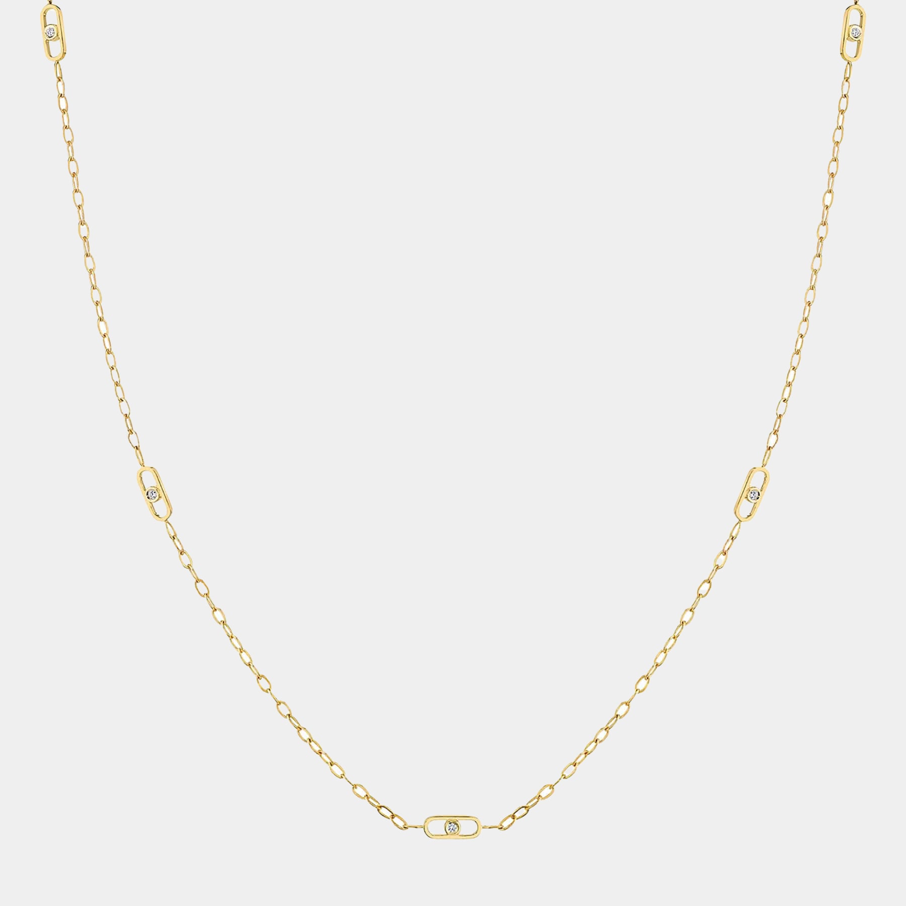 Yellow gold station necklace with diamond paperclip accents on grey background, front view