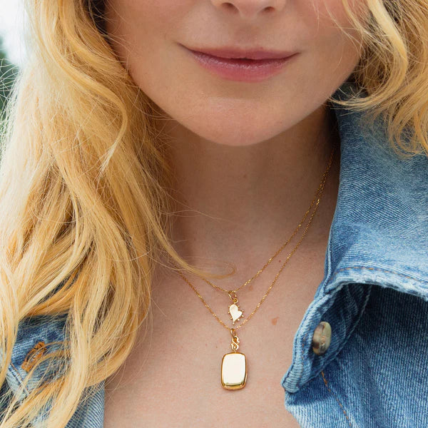 Woman wears Yellow gold locket necklace