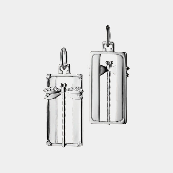 Silver dragonfly pendant on a chain against a grey background