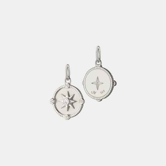 Sterling silver compass pendant necklace on background, front and back view with no chain