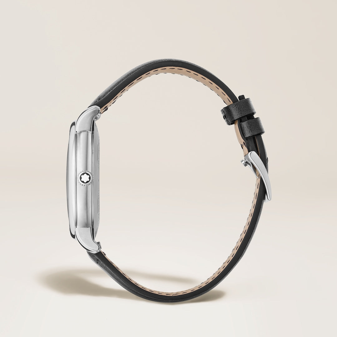 Black watch strap with silver clasp on a light beige background