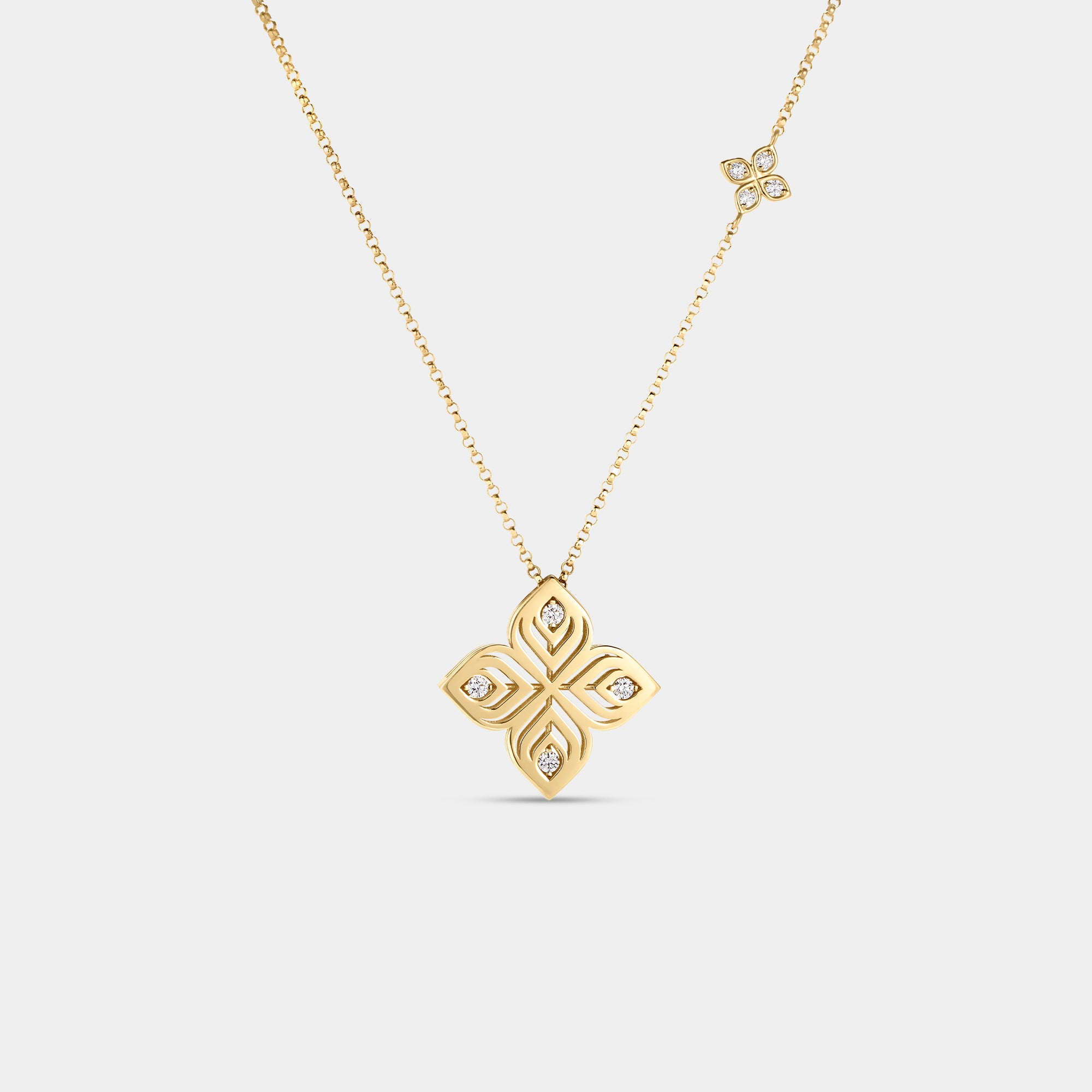 Yellow gold and diamond pendant necklace on a gray background
