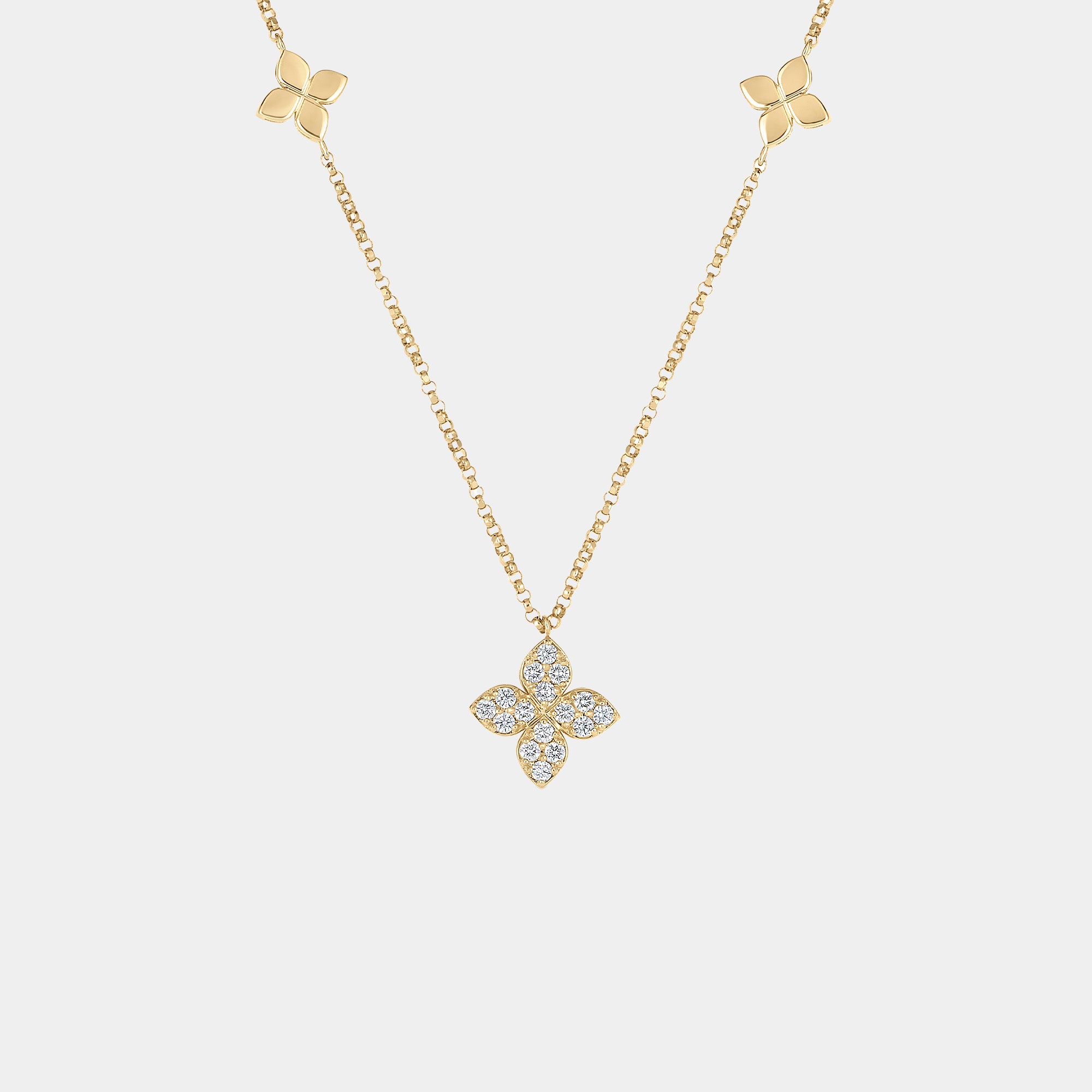 Yellow gold diamond floral pendant necklace on gray background