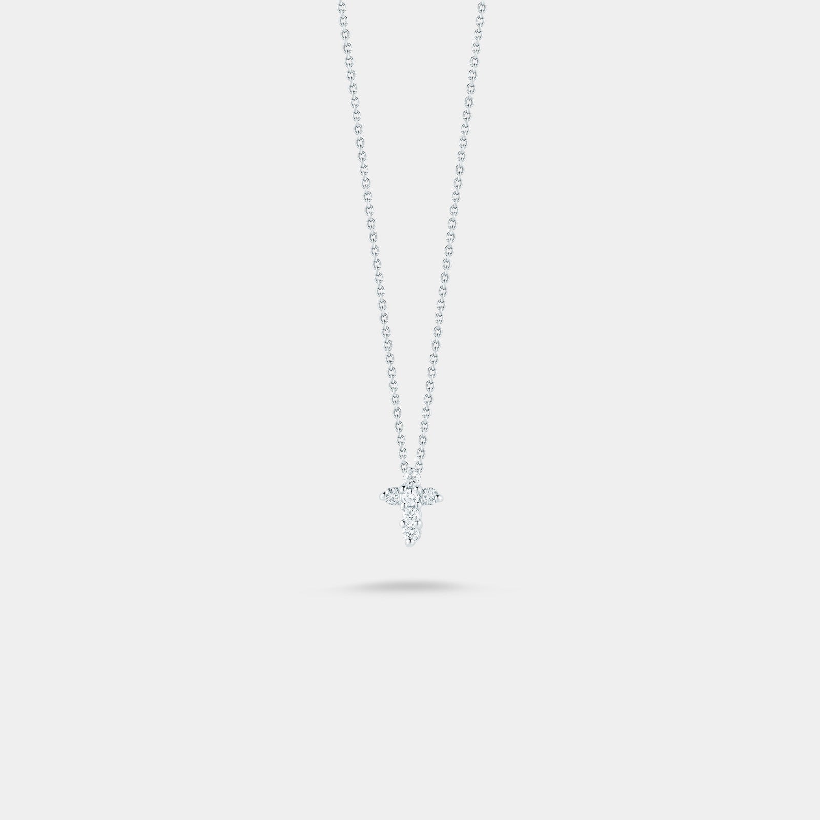 White gold diamond cross pendant necklace on gray background