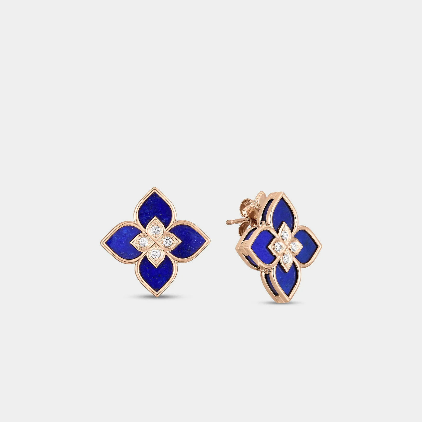 Rose gold blue lapis and diamond flower stud earrings on a gray background.