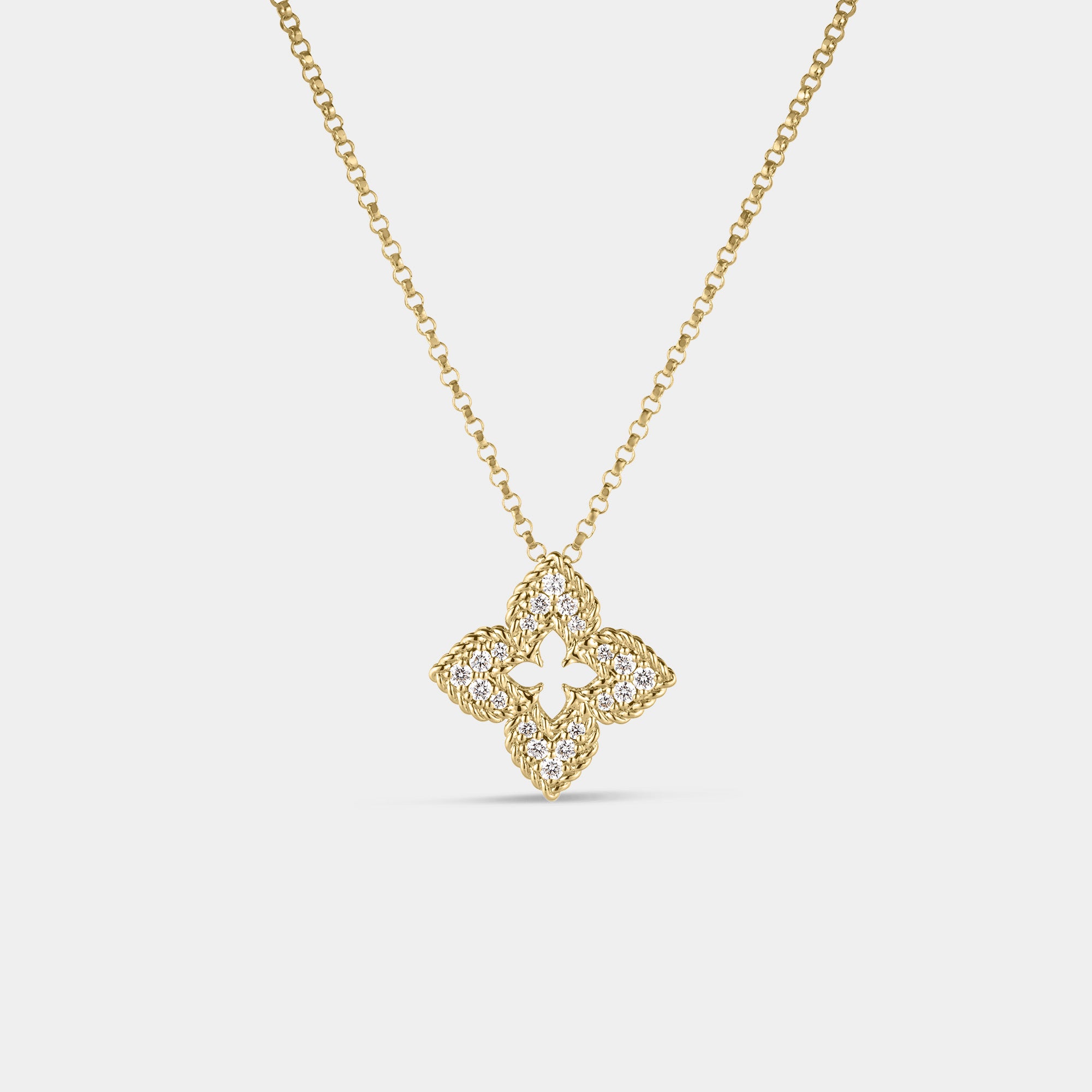 Yellow gold diamond floral necklace on a gray background.