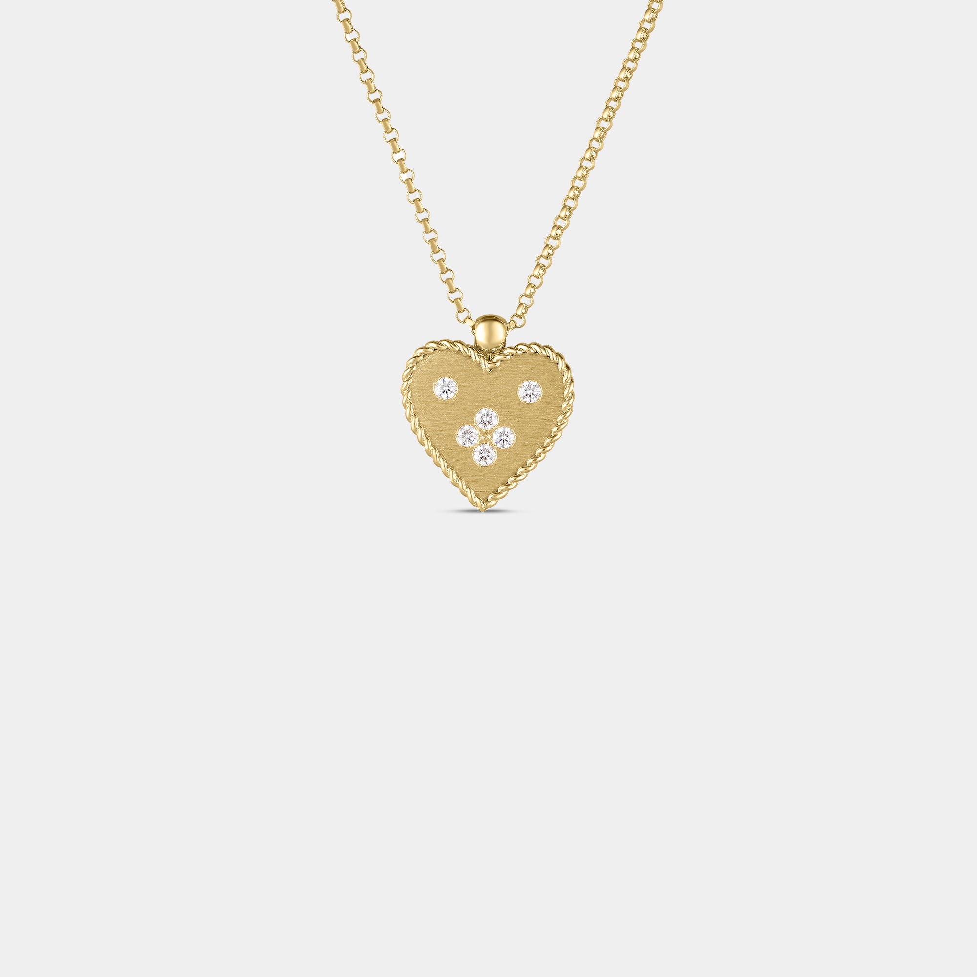 Yellow gold diamond heart pendant necklace on gray background