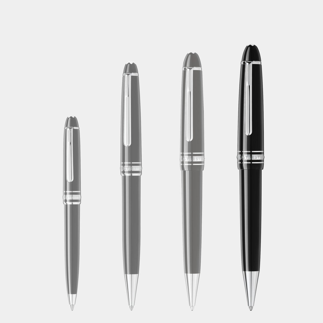 Set of four montblanc pens with black and silver accents on a light gray background
