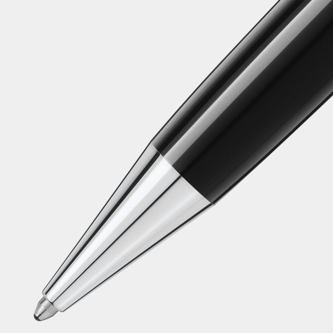 Close-up of a montblanc black and silver pen on a light gray background