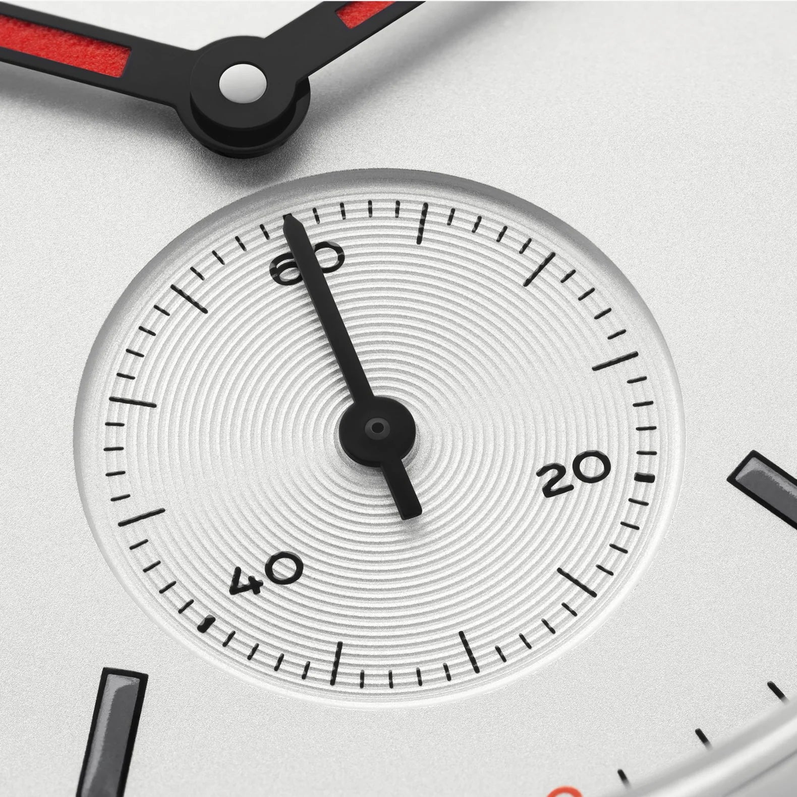 NOMOS Glashütte Club 36mm watch with white silver-plated dial, black and red hands, sub dial closeup