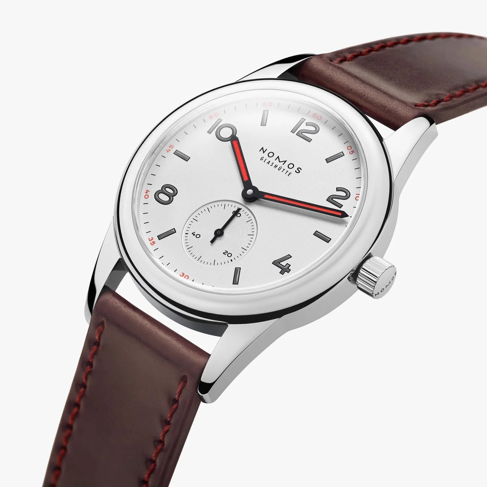 NOMOS Glashütte Club 36mm watch with white silver-plated dial, black and red hands, and brown Horween leather strap on white background, side angle view.