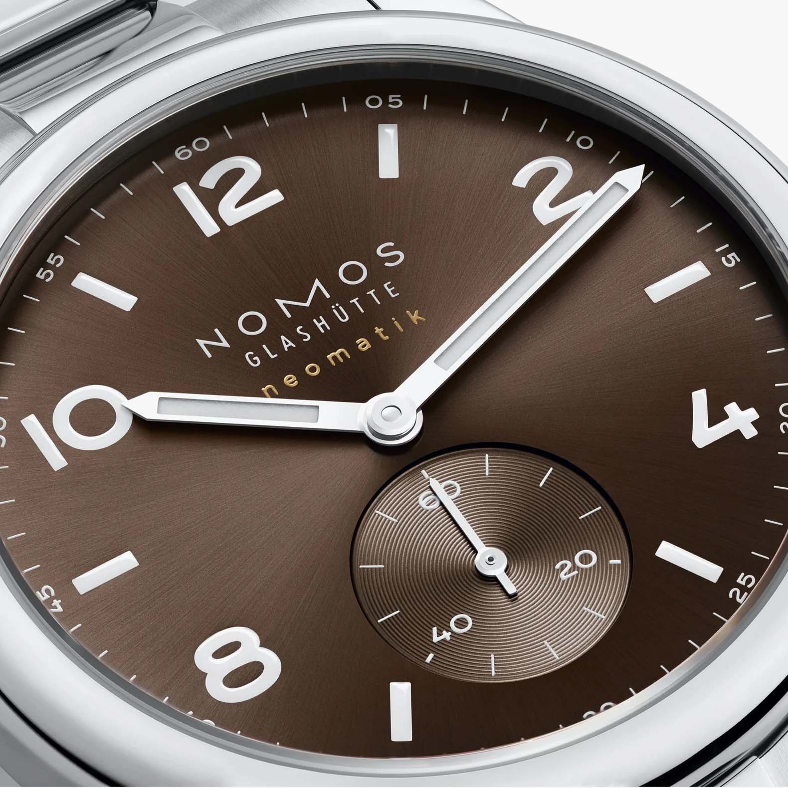 NOMOS Glashütte Club Sport Neomatik 39mm watch with tabac brown sunburst dial, luminous hands, closeup of dial
