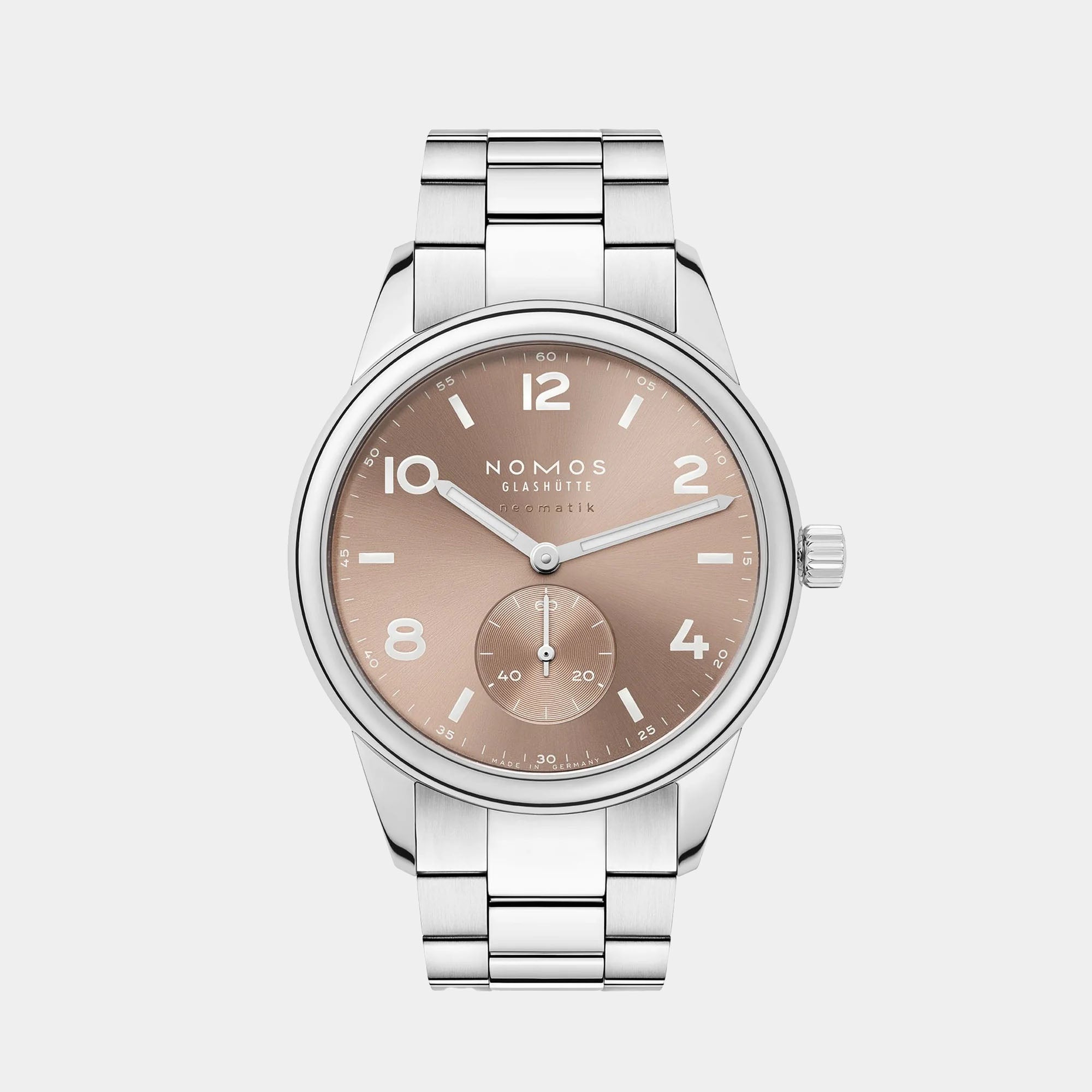 NOMOS Glashütte Club Sport Neomatik 39mm watch with ember beige-gold sunburst dial, luminous hands, and stainless steel bracelet on grey background.
