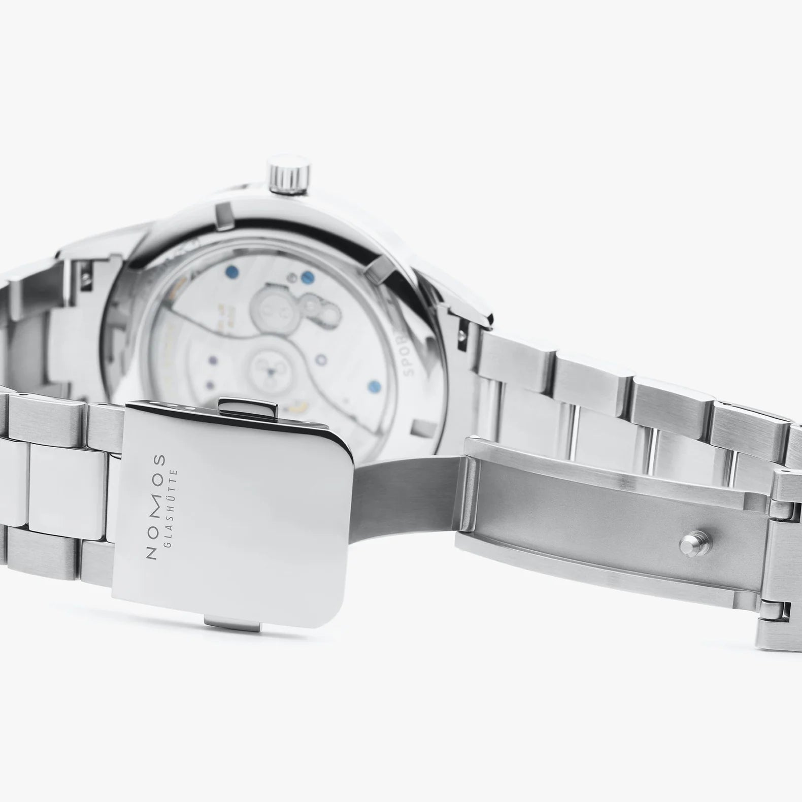 NOMOS Glashütte Club Sport Neomatik 42mm watch with black dial, luminous hands, and stainless steel bracelet on grey background, clasp closeup