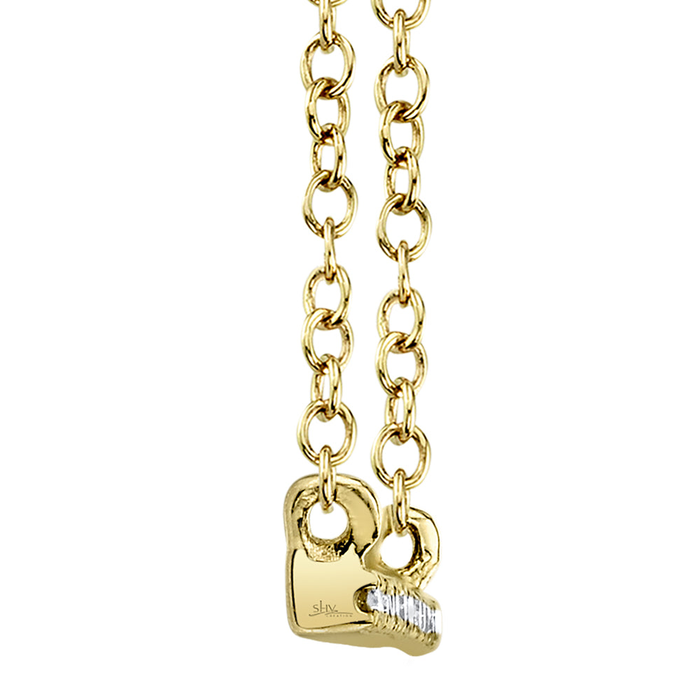 Side view of gold bar pendant with a diamond on a gold chain against a white background