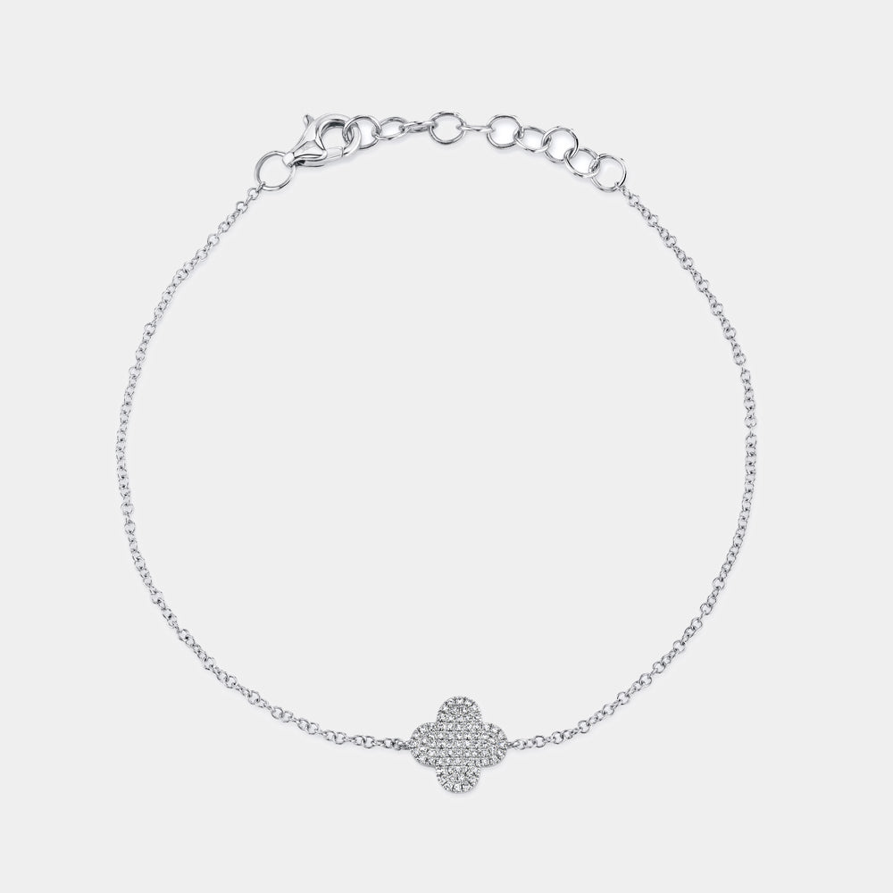 White gold diamond clover charm bracelet, flat lay on grey background