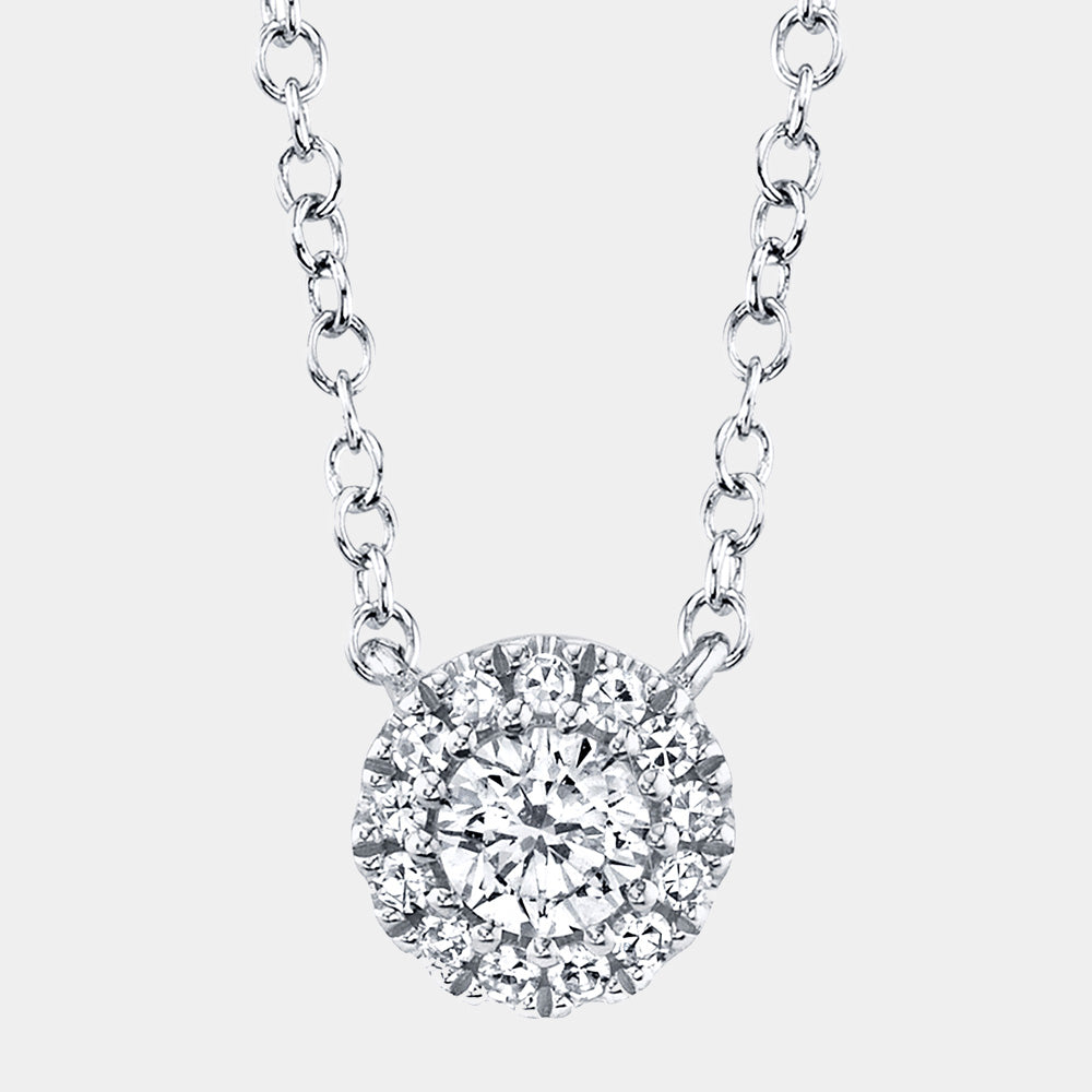 White gold diamond necklace on a light gray background