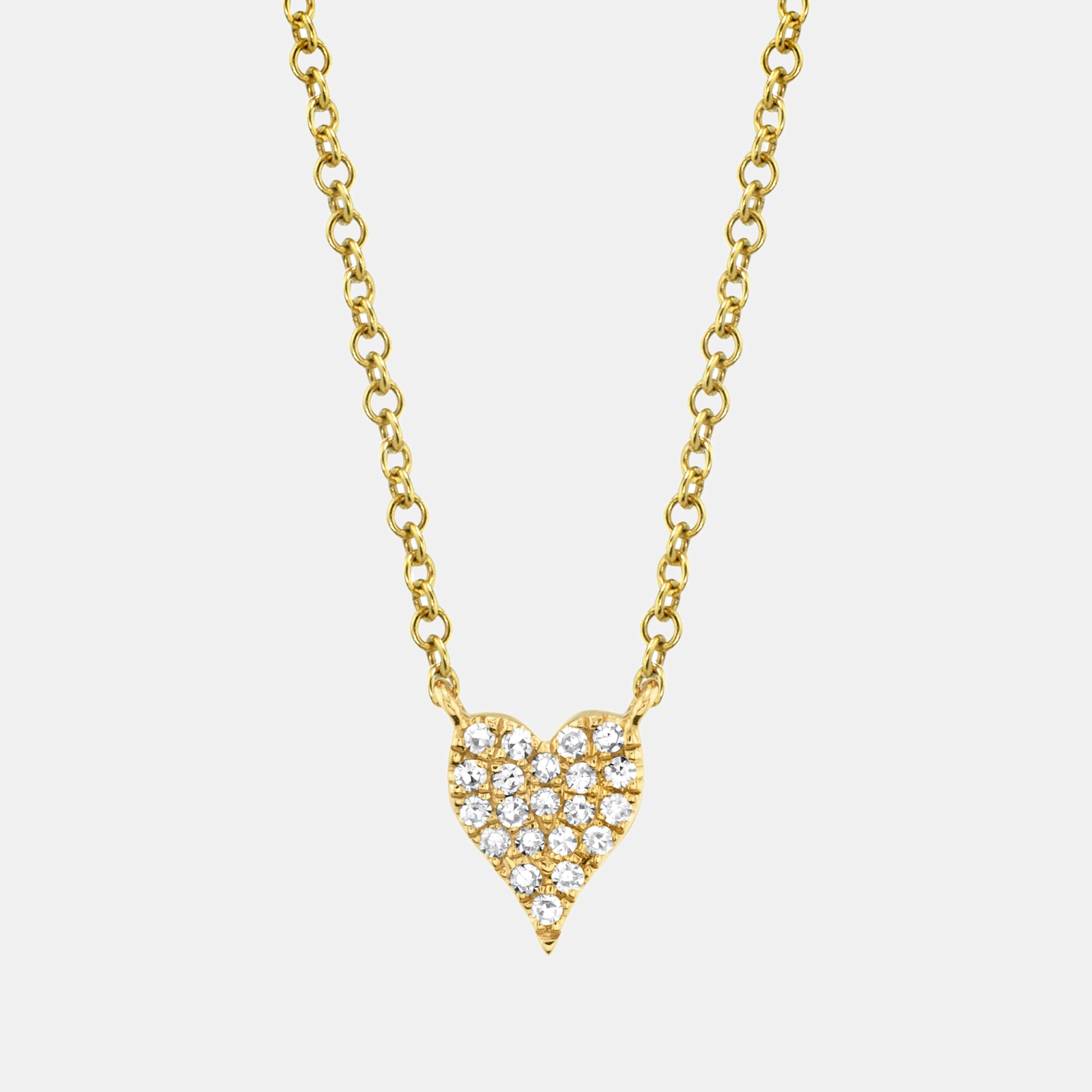 Gold necklace with a heart-shaped pendant on a light gray background
