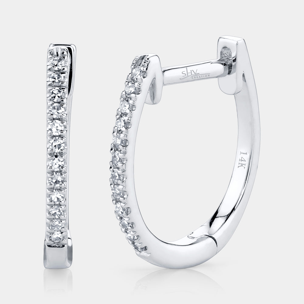 White gold diamond huggie earrings, front angle view