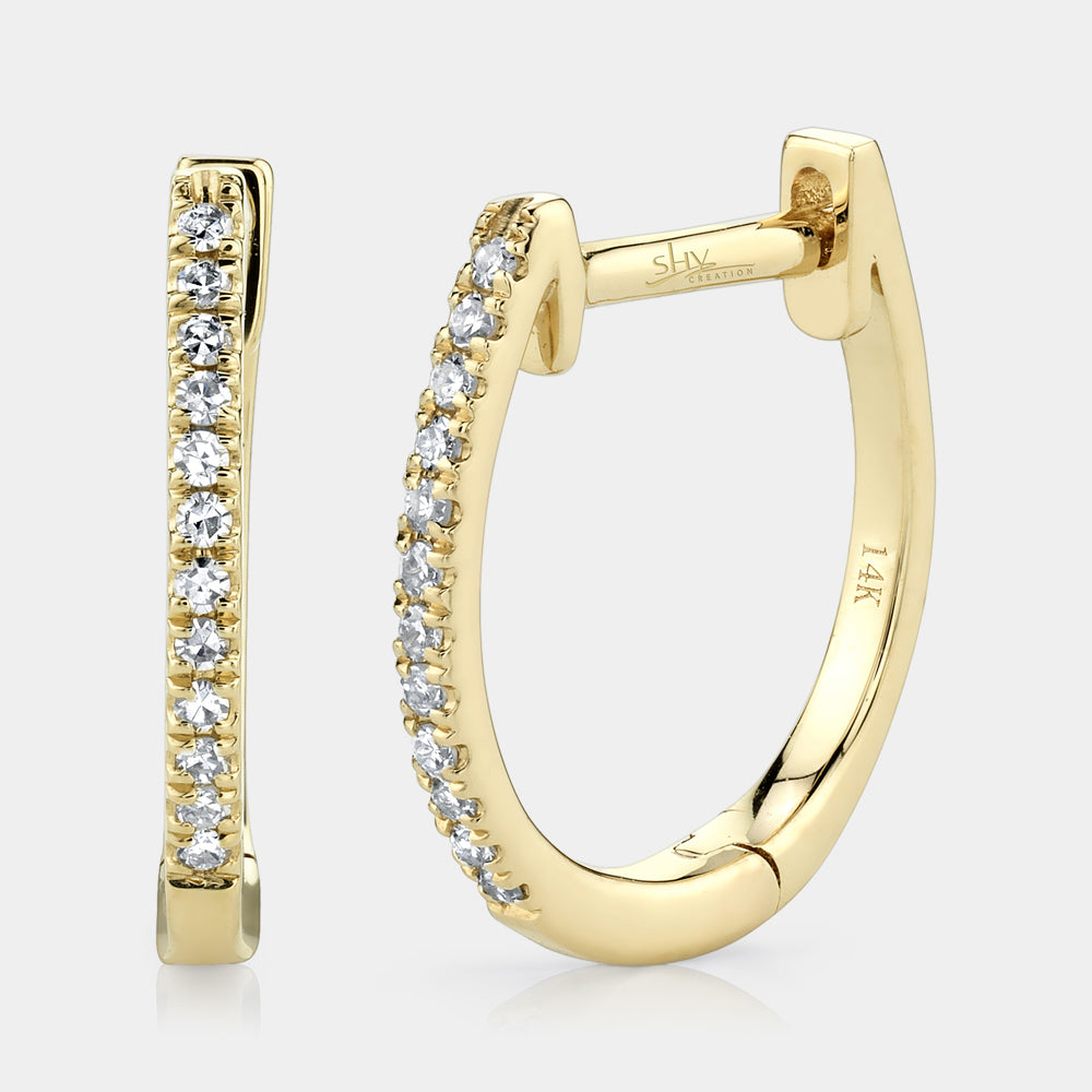Yellow gold diamond huggie earrings, front angle view