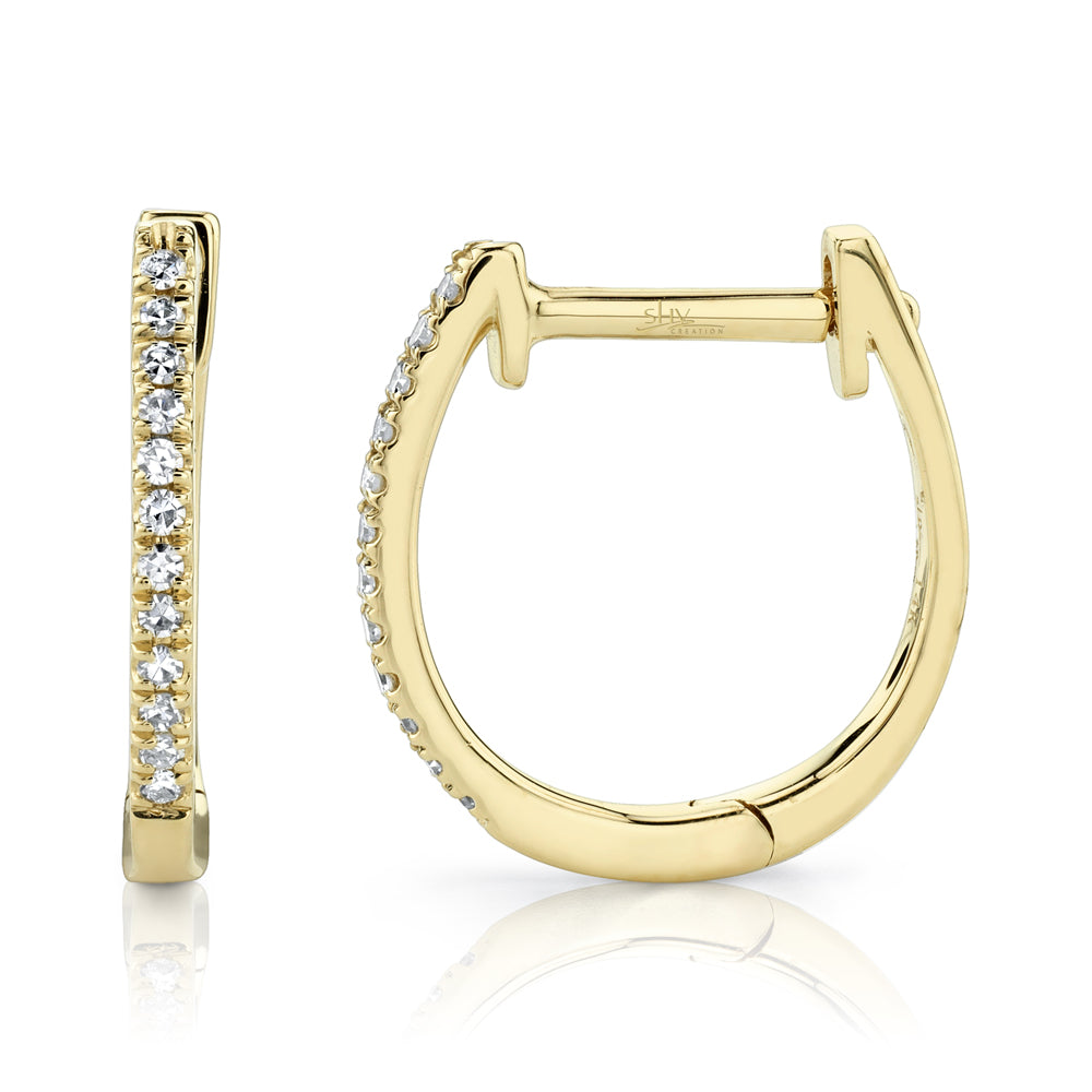 Yellow gold diamond huggie earrings, side angle view