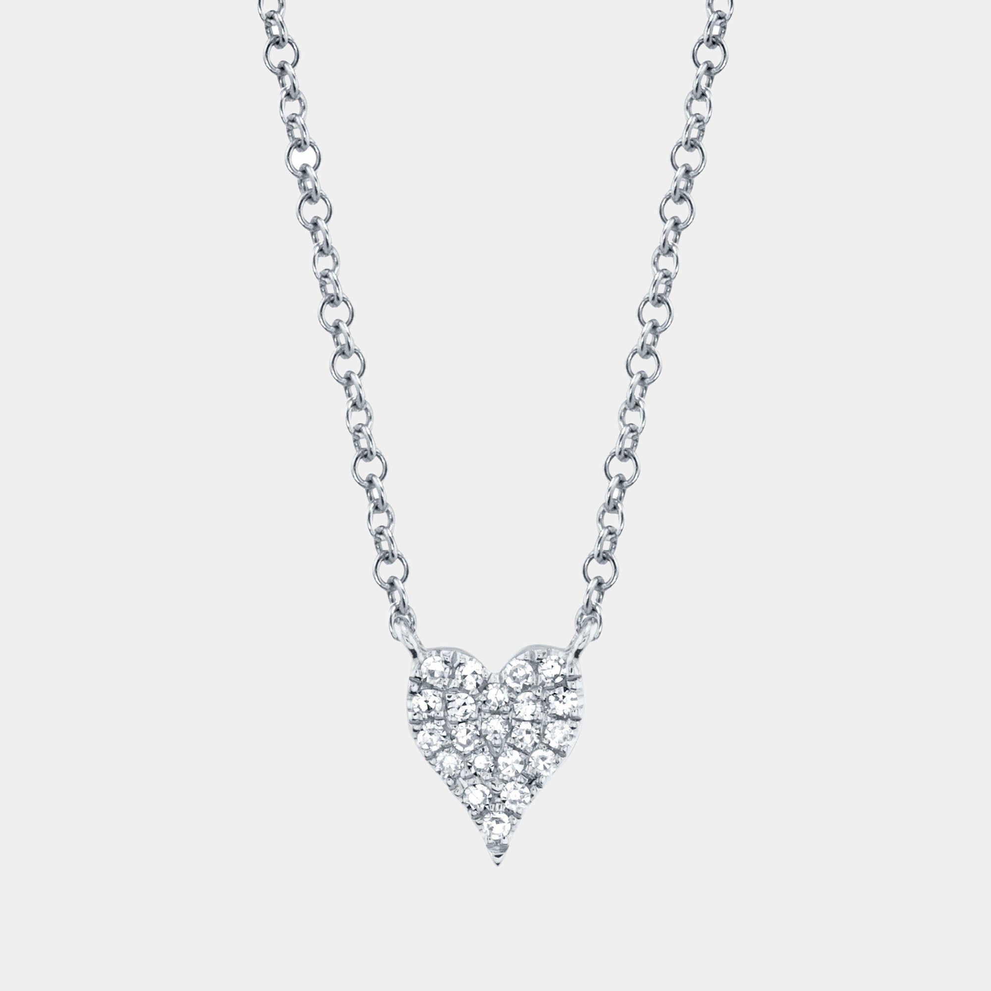 Heart-shaped diamond necklace on a light gray background