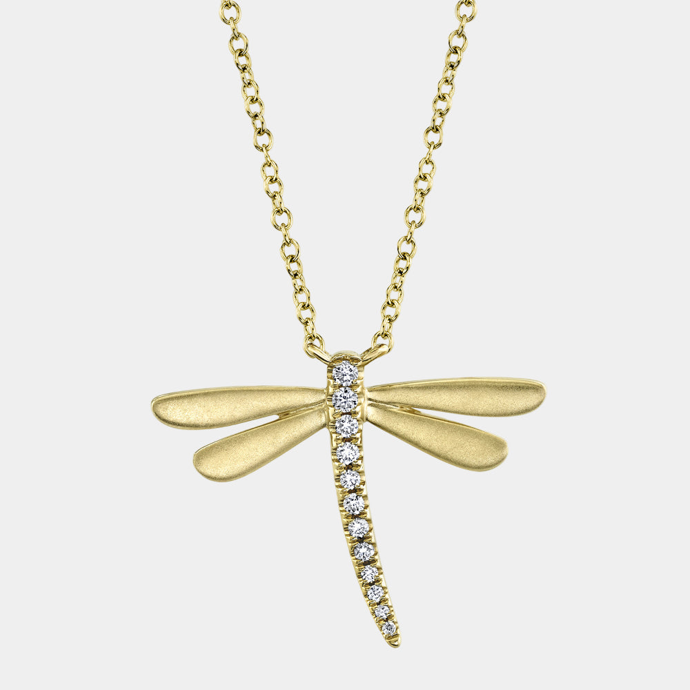 Gold dragonfly necklace with diamond accents on a light gray background