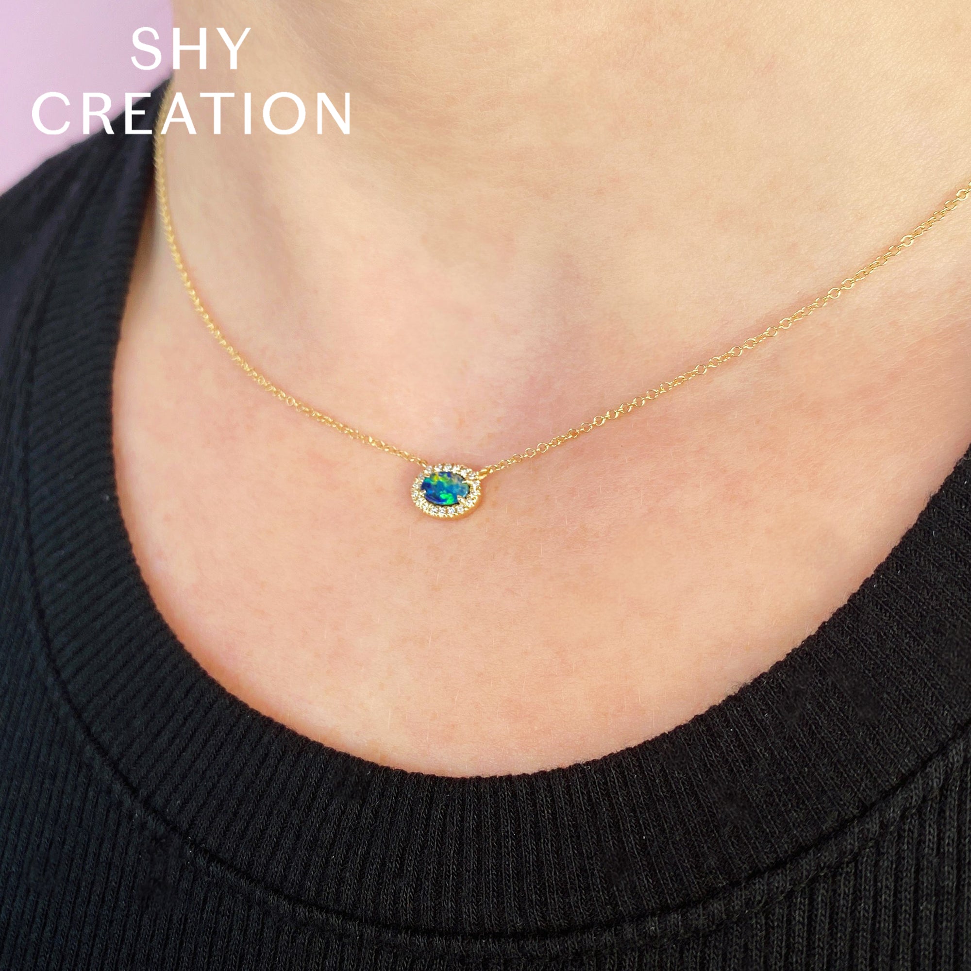 Gold necklace with an opal pendant pendant worn by a women