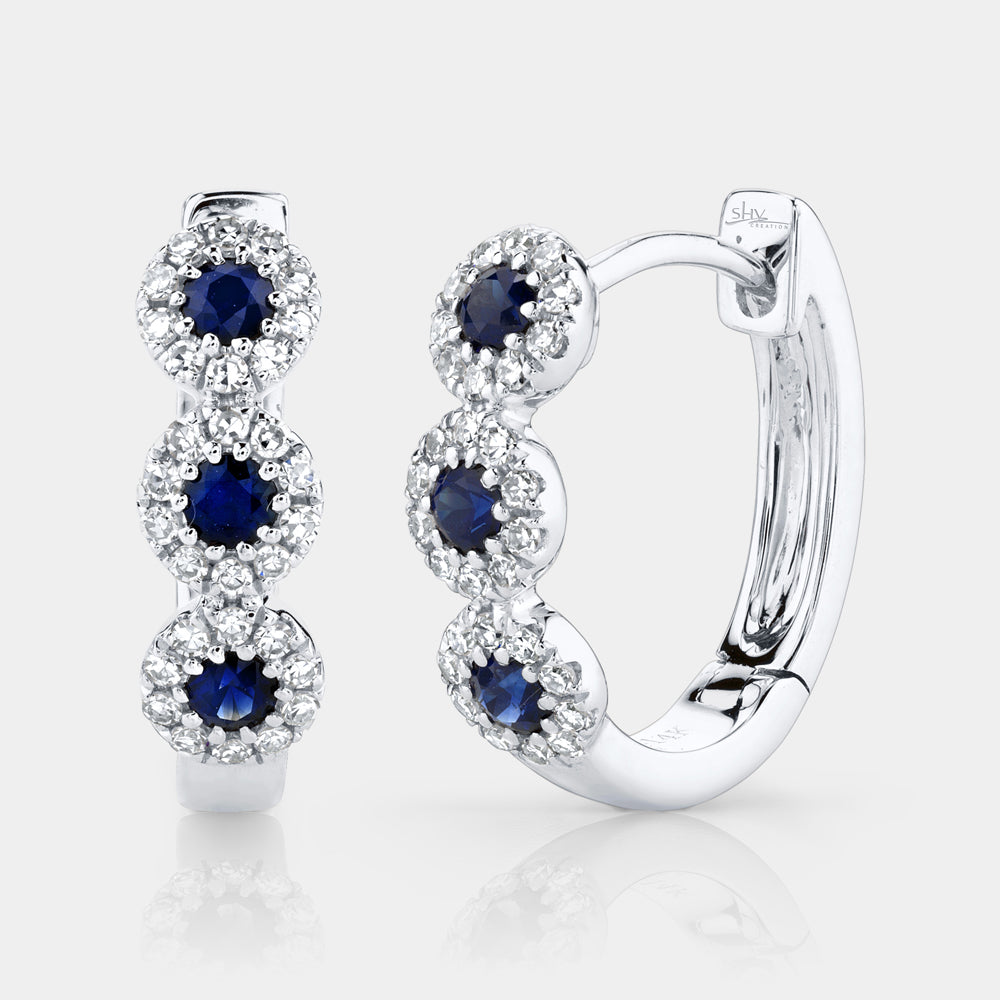 White gold sapphire and diamond huggie earrings, front angle view