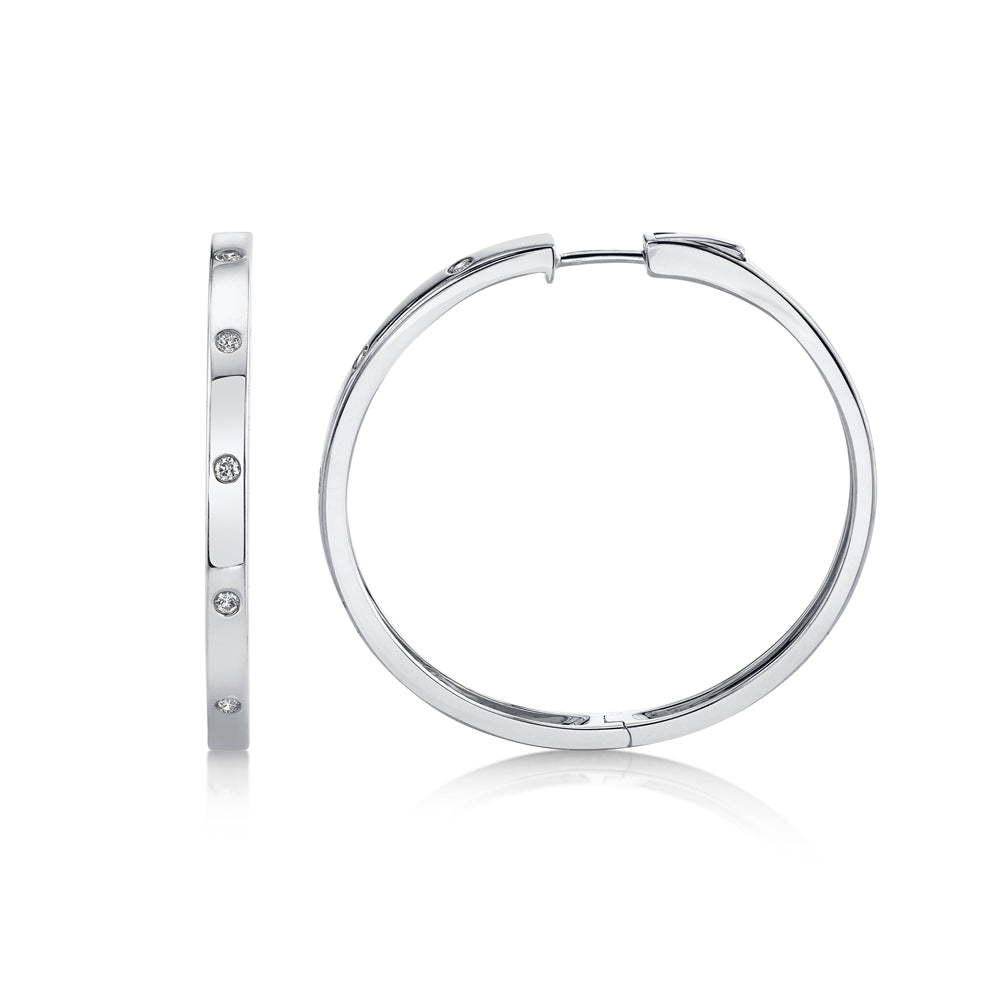White gold diamond bezel set hoop earrings, side angle view