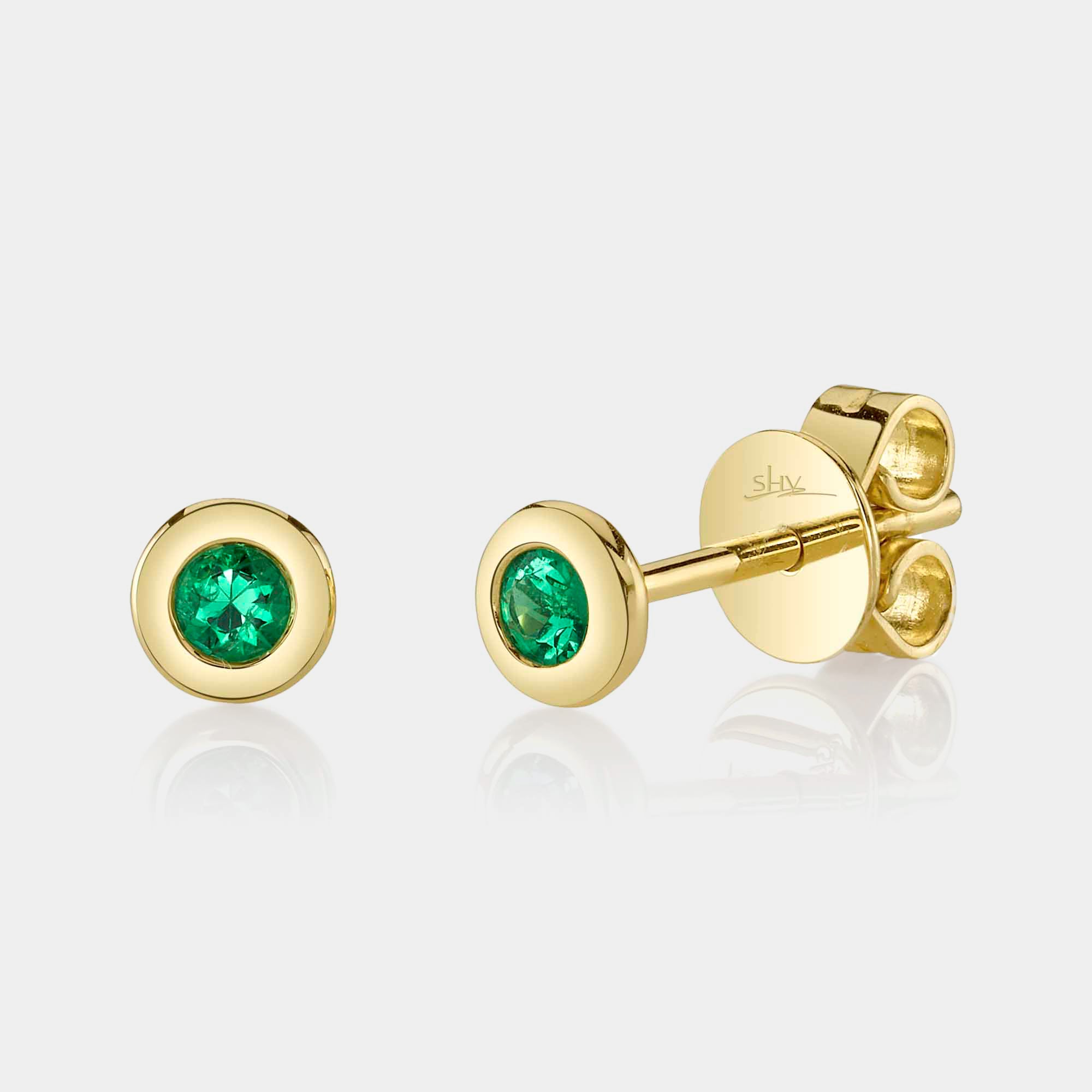 Yellow gold bezel set emerald stud earrings, front angle view