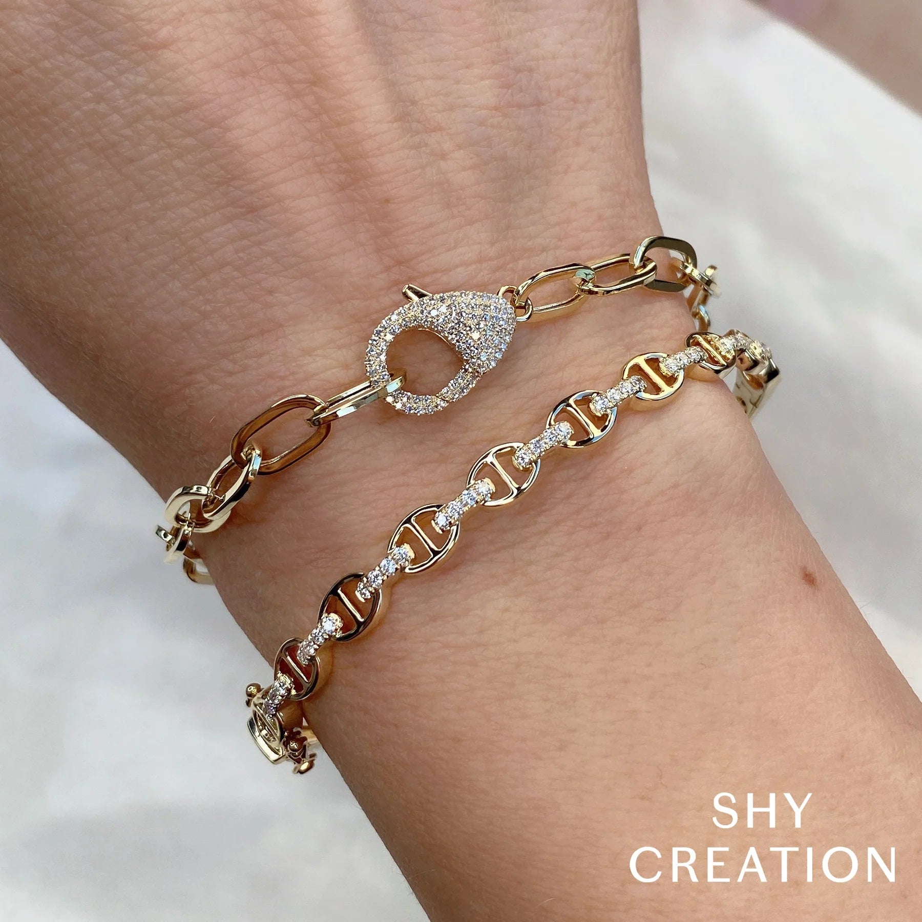 Woman wearing yellow gold diamond link bracelet, close-up of wrist