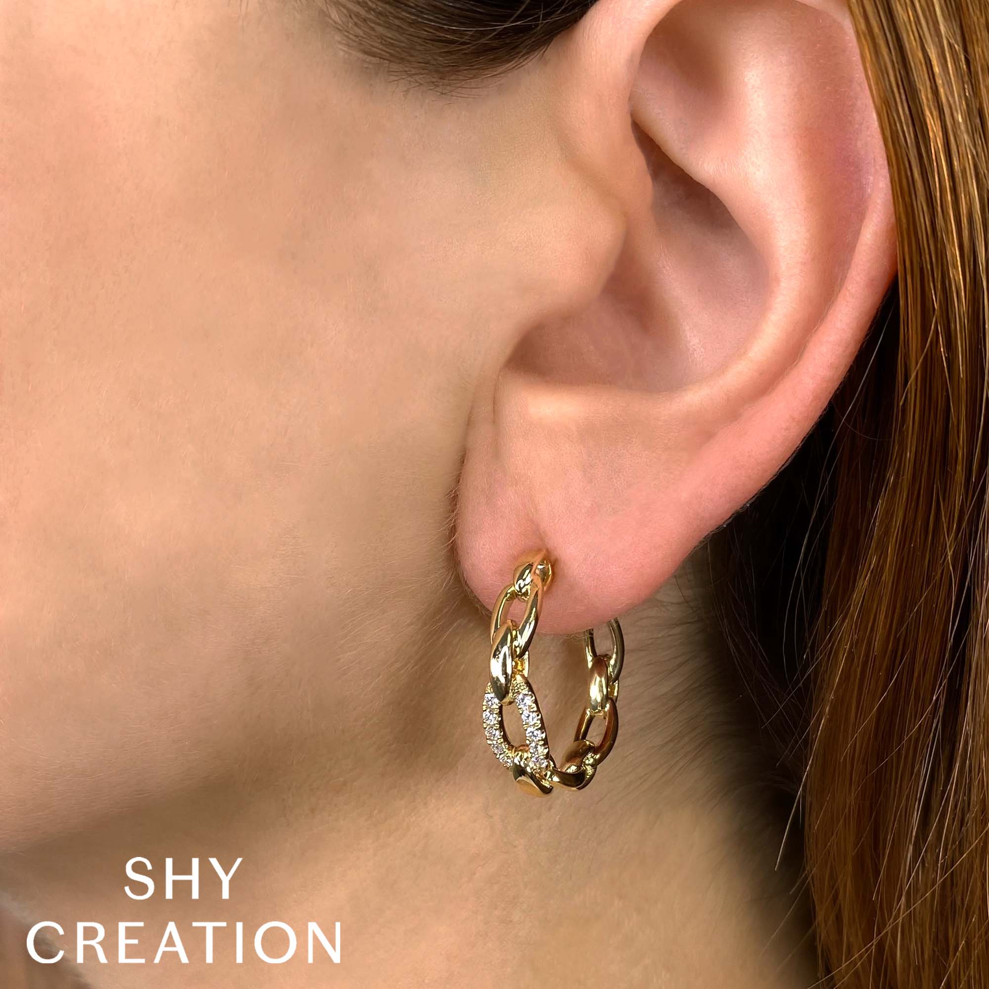 Woman wearing yellow gold diamond paperclip link hoop earrings
