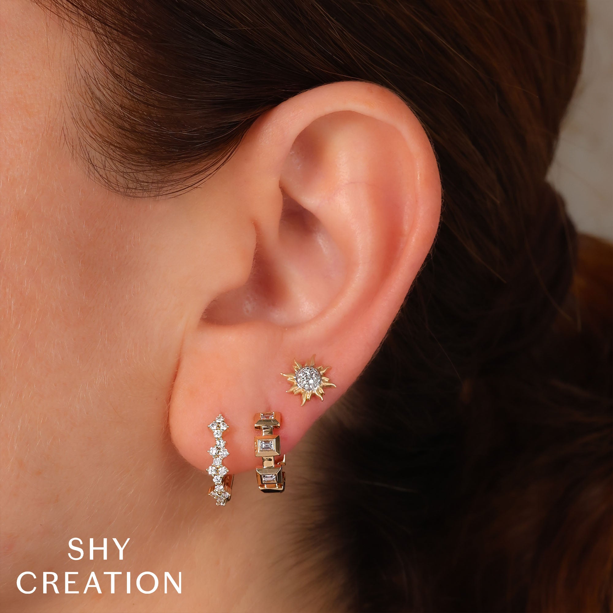 Woman wearing yellow gold pave diamond sun stud earrings