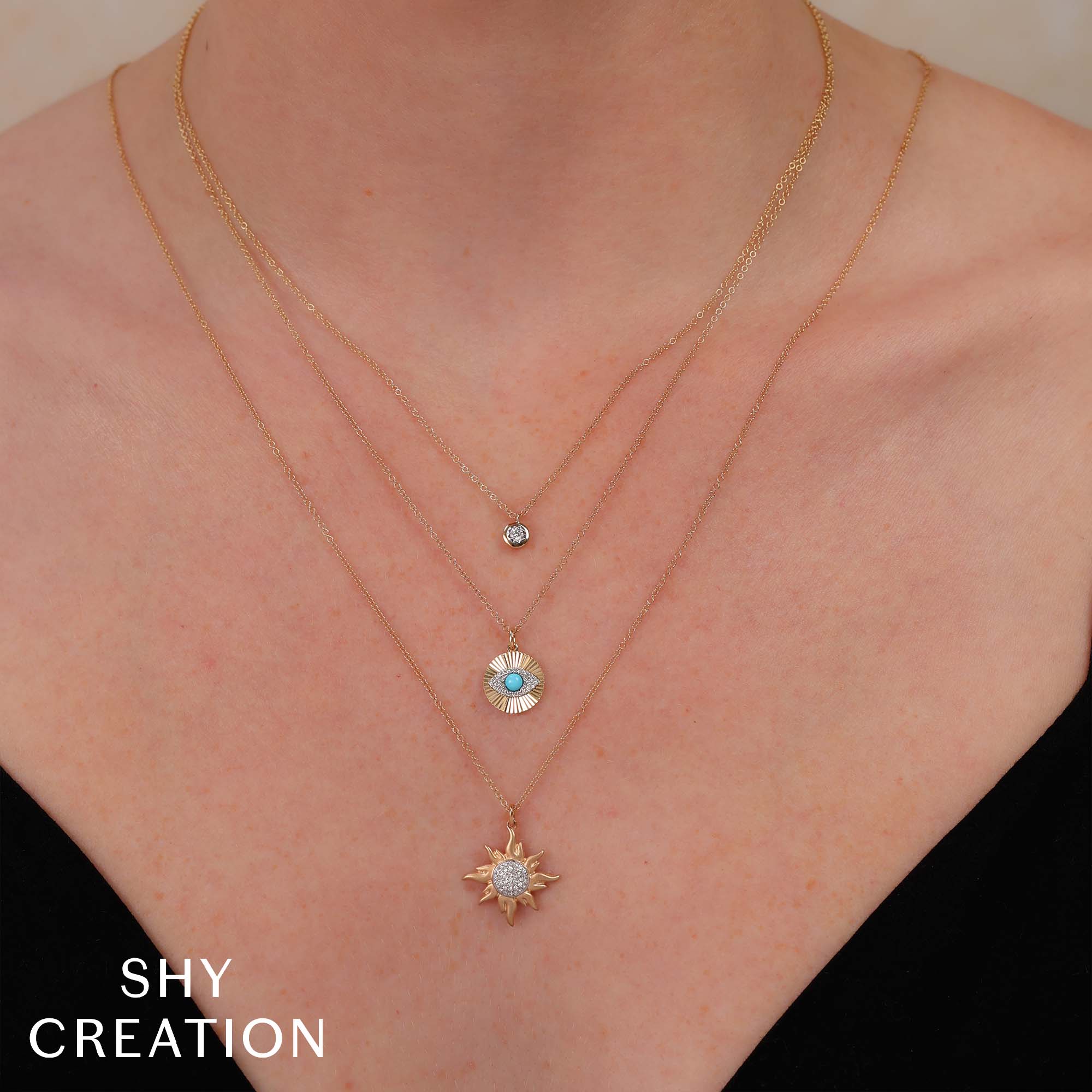 Woman wearing yellow gold pave diamond sun pendant necklace