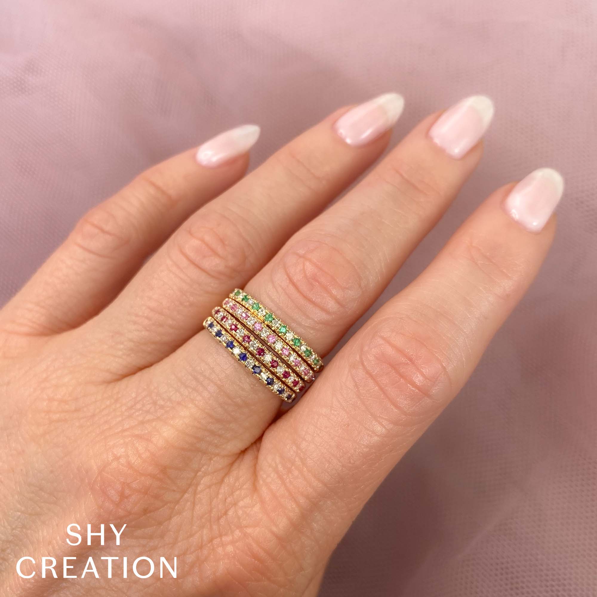 Women wearing yellow gold, ruby and diamond stacking fashion ring