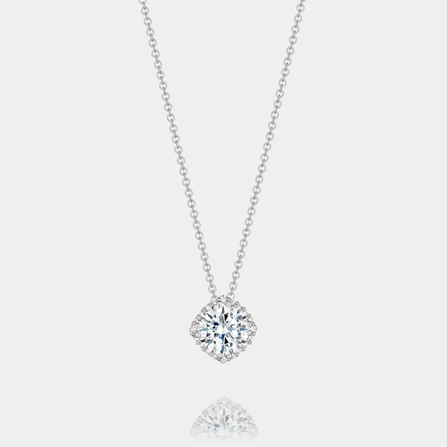18K White Gold Round Diamond Pendant Necklace on grey background.
