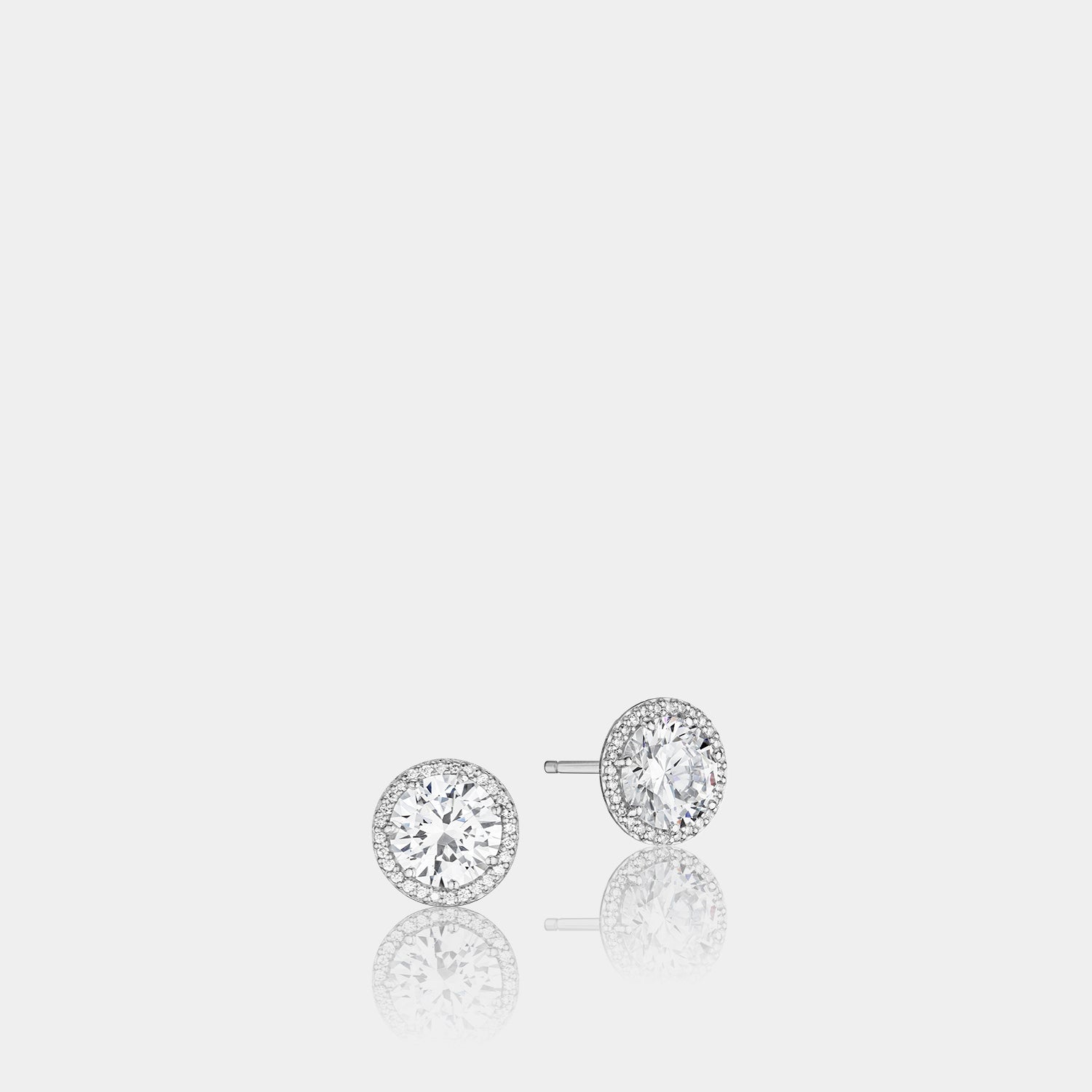 White Gold Round Diamond Stud Earrings on grey background.