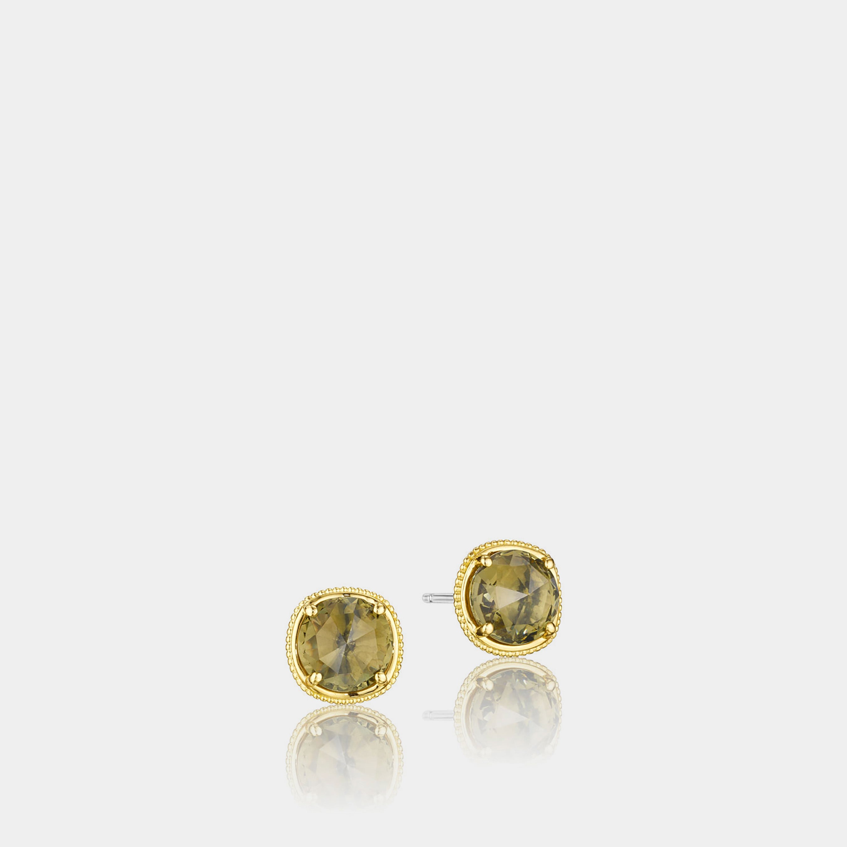 Sterling Silver and Yellow Gold Olive Quartz Stud Earrings on grey background.