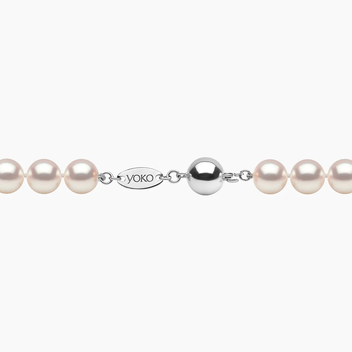 Pearl necklace with white gold clasp on a white background