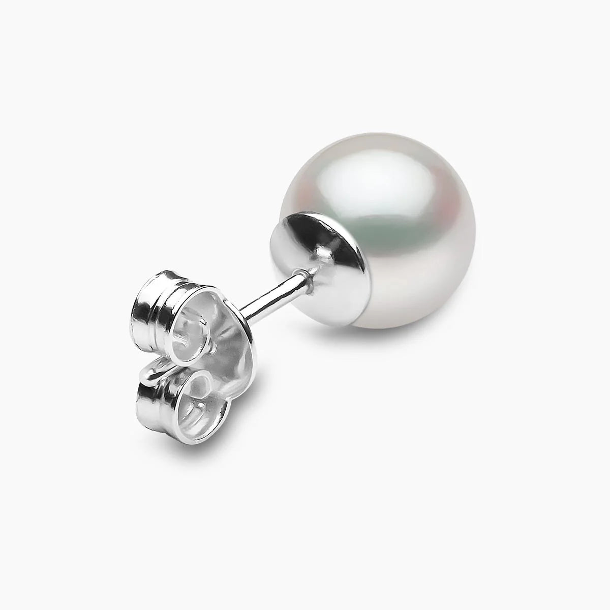 Pearl earring on a light gray background, rear angle view
