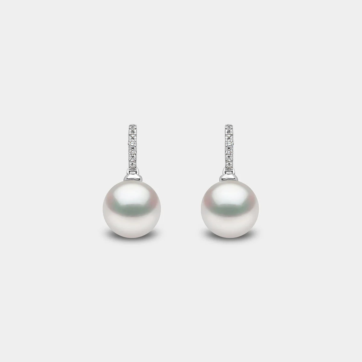 White gold pearl drop earrings with diamond accents, front view