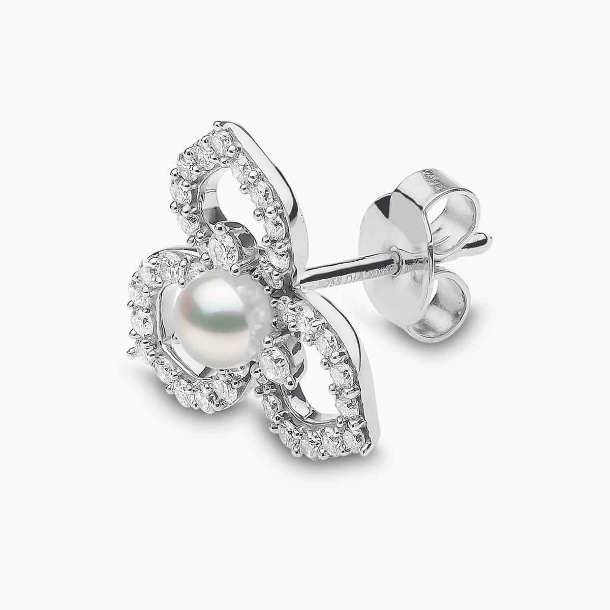 White gold pearl and diamond floral pattern stud earring on grey background, side angle view