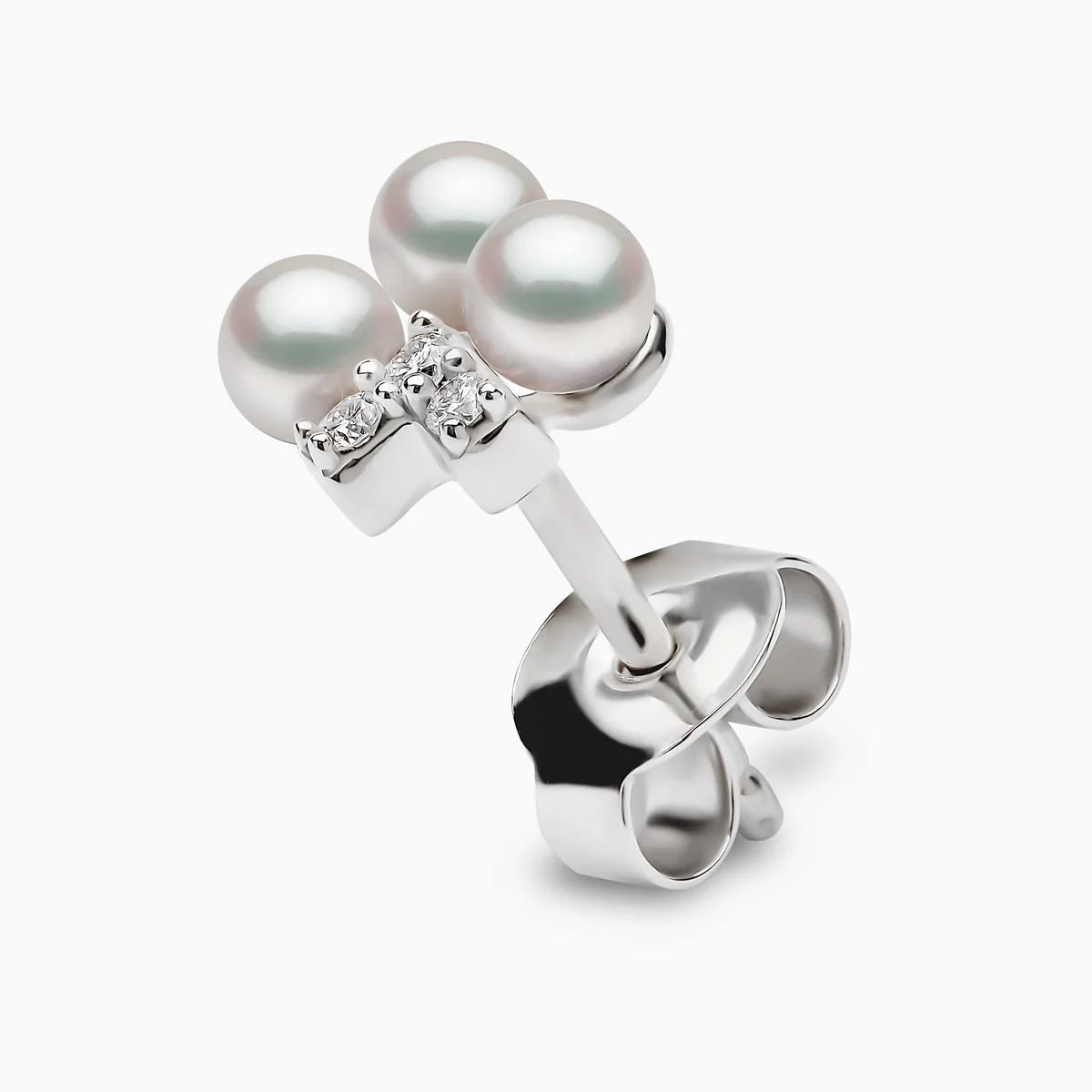 White gold pearl and diamond v drop earring on grey background, side view