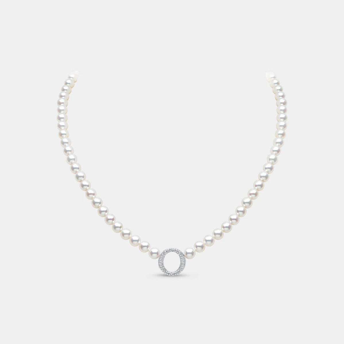 Pearl strand necklace with white gold letter o diamond pendant on grey background, front view