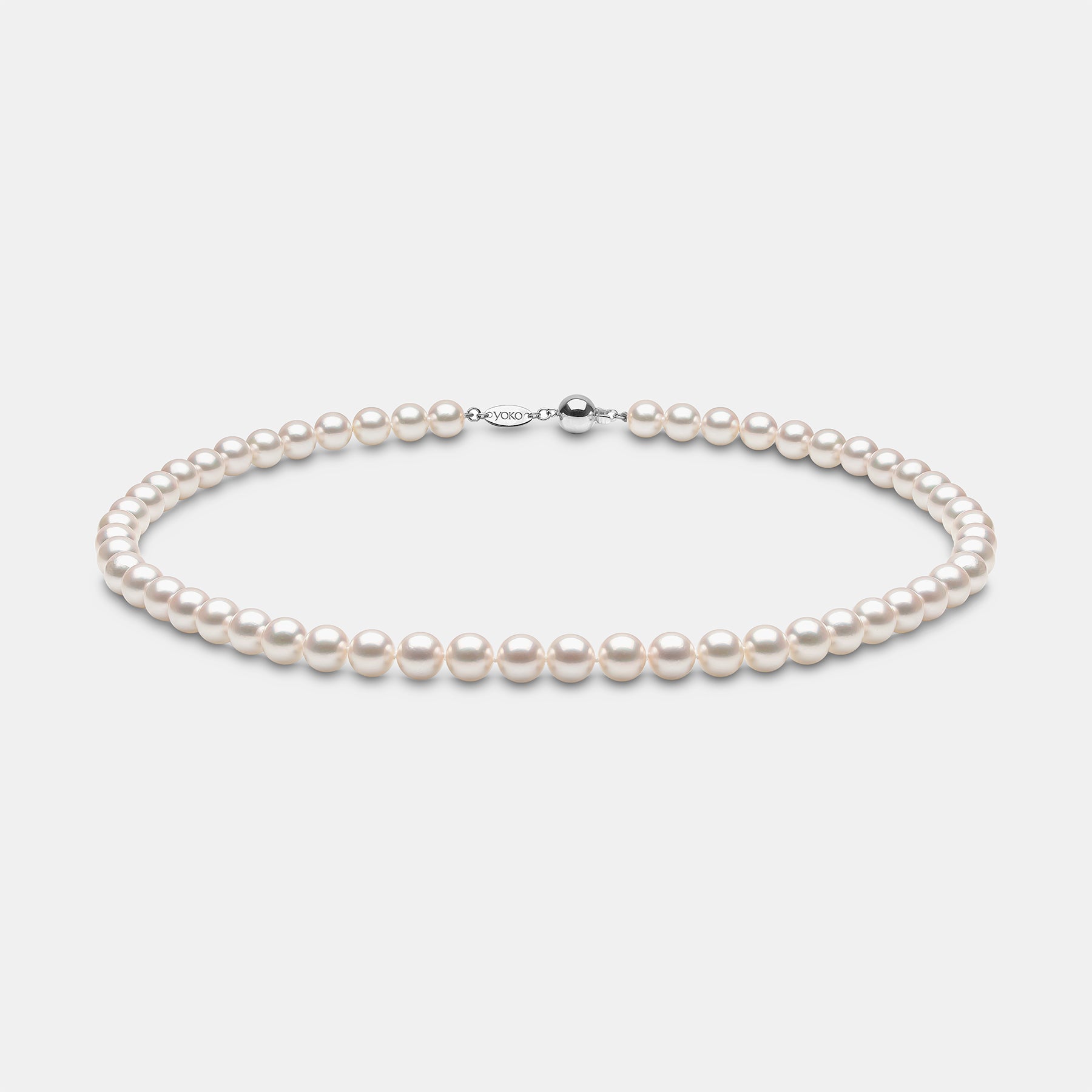 Pearl strand necklace on grey background, front view